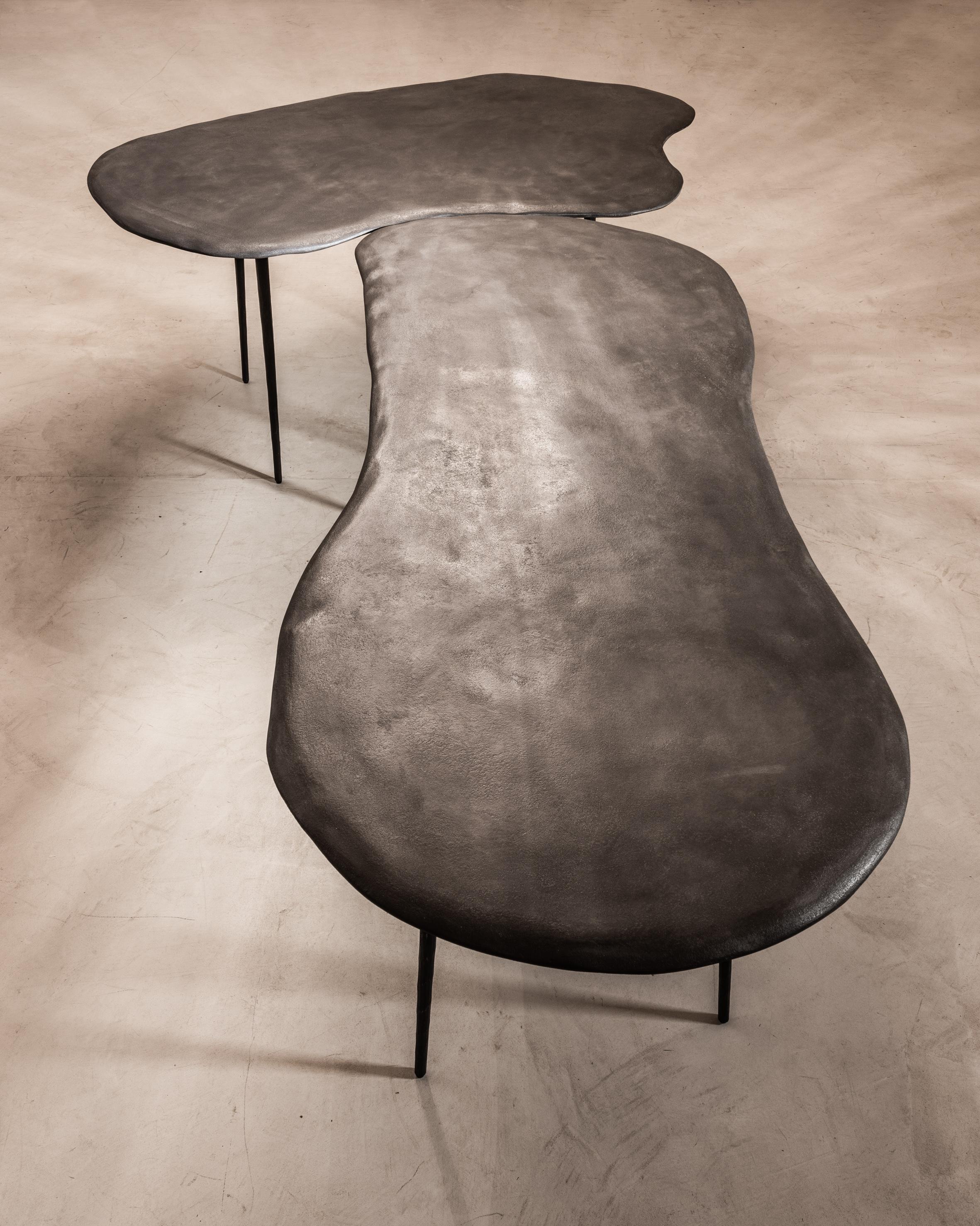 Varenna table duo by Studio Emblématique
Dimensions: 
- W 157 x D 92 x H 76 cm
- W 162 x D 95 x H 76 cm

Materials: Stonegrain table top with conical metal hammered legs

Pushing the boundaries, going the extra mile to find the extraordinary