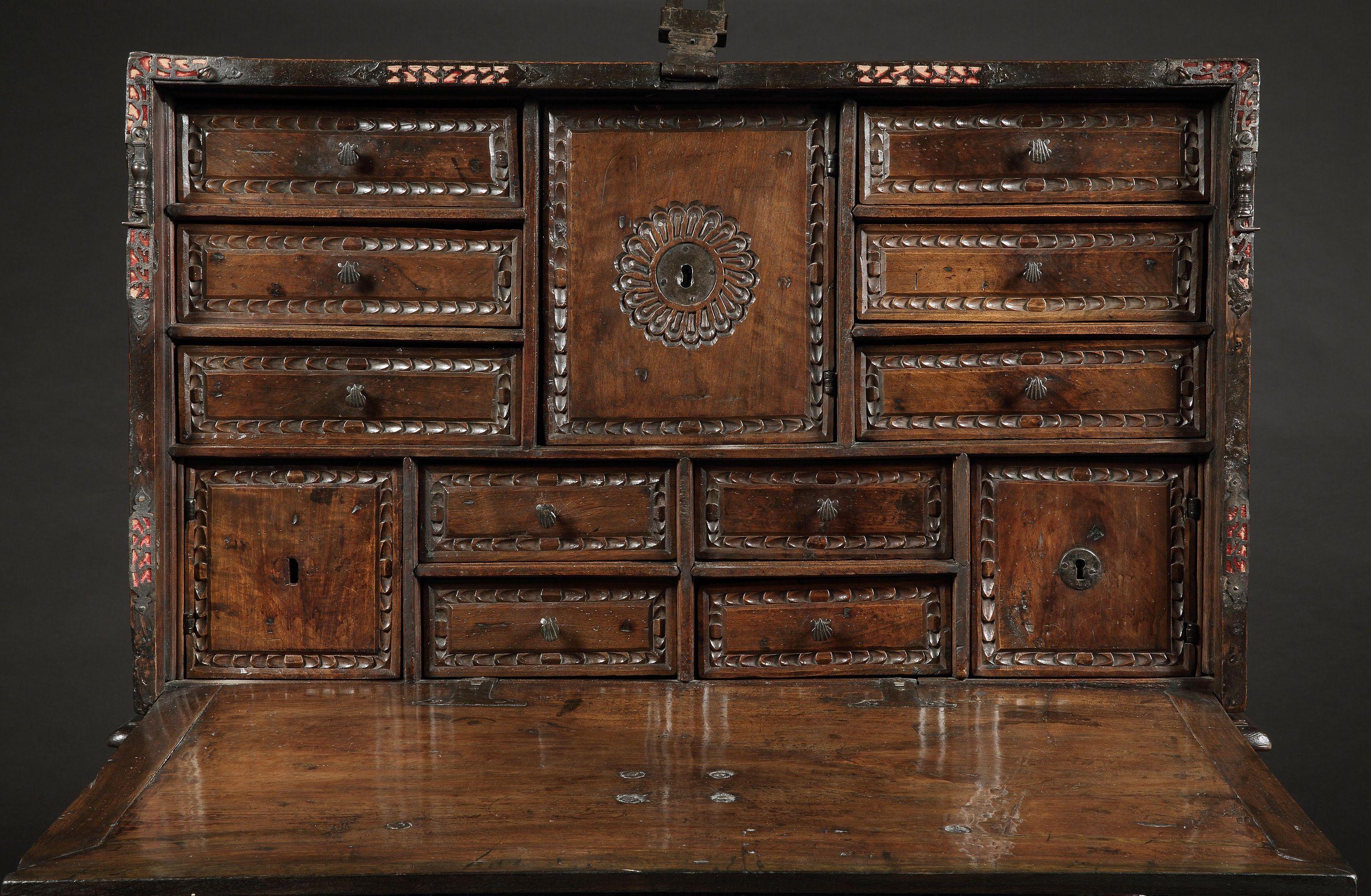 Spanish writing desks of this period are the most distinctive pieces of Spanish furniture conceived as visual displays of incredible virtuosity. The characteristic decoration of the outer fall front with its metal pierced mounts over red velvet,