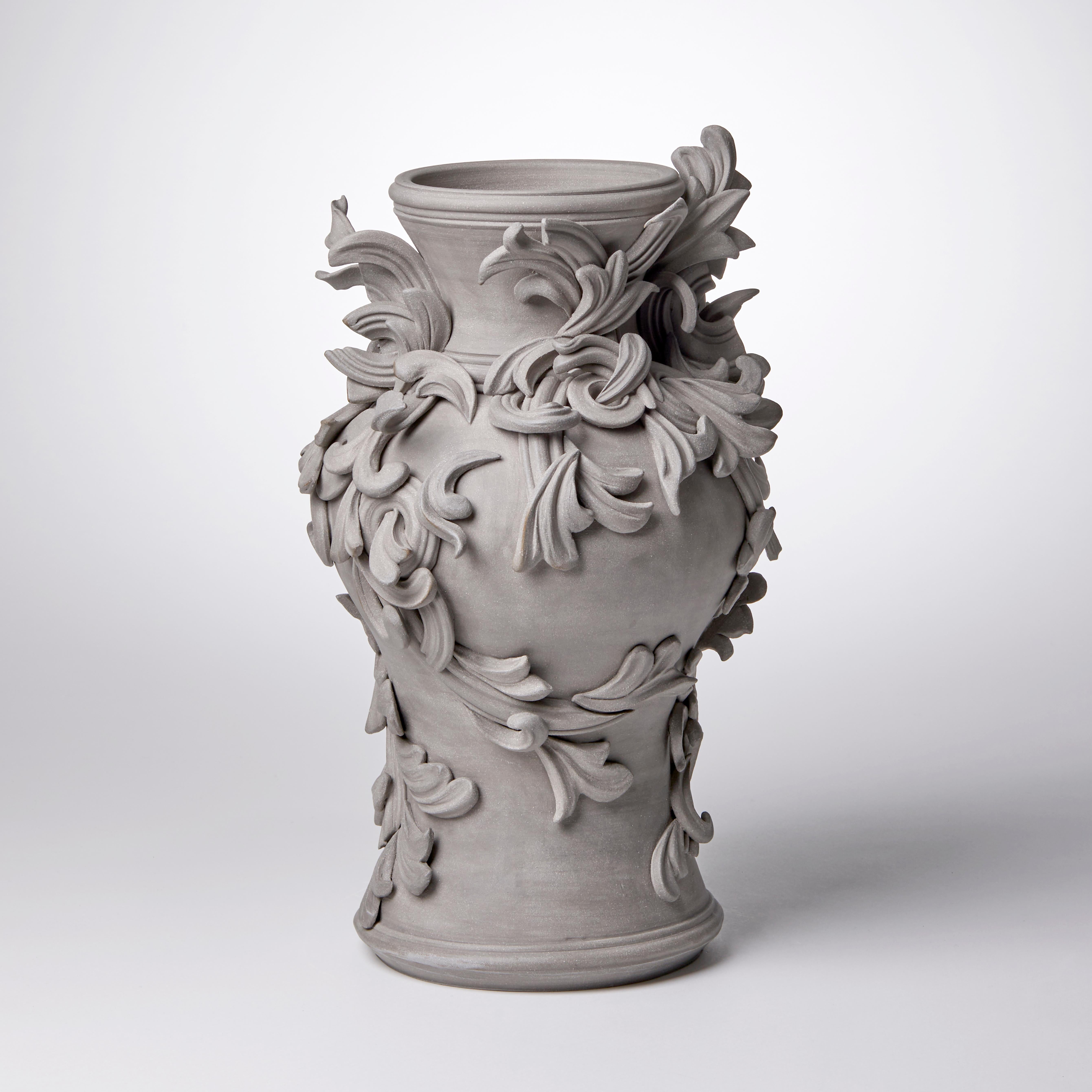 Vari Capitelli X is a unique handmade colored stoneware ceramic sculptural vase in warm grey by the British artist Jo Taylor. The central form has been thrown on the potter's wheel and also hand-built, then adorned with architectural inspired
