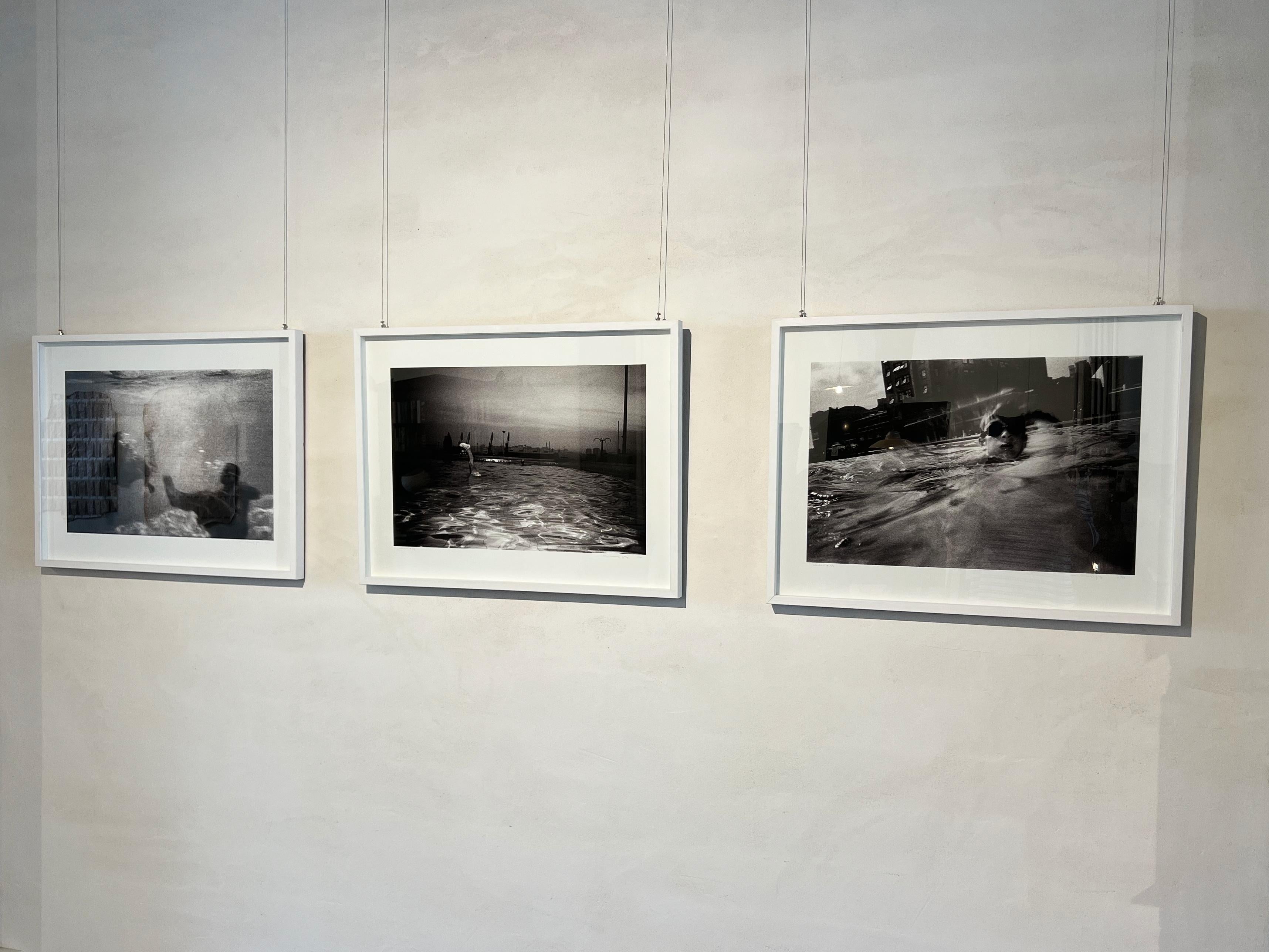 Analog photography of swimmers, lights in the water, moving image, black & white - Post-Modern Photograph by Vari Caramés