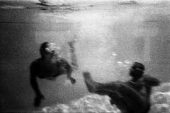 Analog photography of swimmers, lights in the water, moving image, black & white