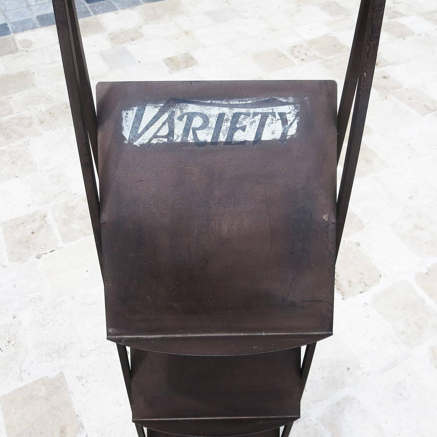 Variety magazine, founded in 1905, was the main conduit for all information on the film trade in Hollywood. This iron stand was provided by Variety to the Ambassador Hotel (1921-2005) in Los Angeles. The Ambassador was the center of Hollywood