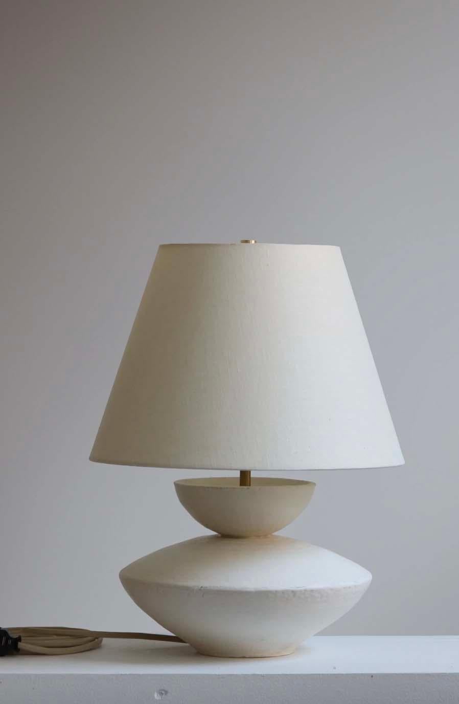The Varinia lamp is handmade studio pottery by ceramic artist by Danny Kaplan. Shade included. Please note exact dimensions may vary.

Born in New York City and raised in Aix-en-Provence, France, Danny Kaplan’s passion for ceramics was shaped by