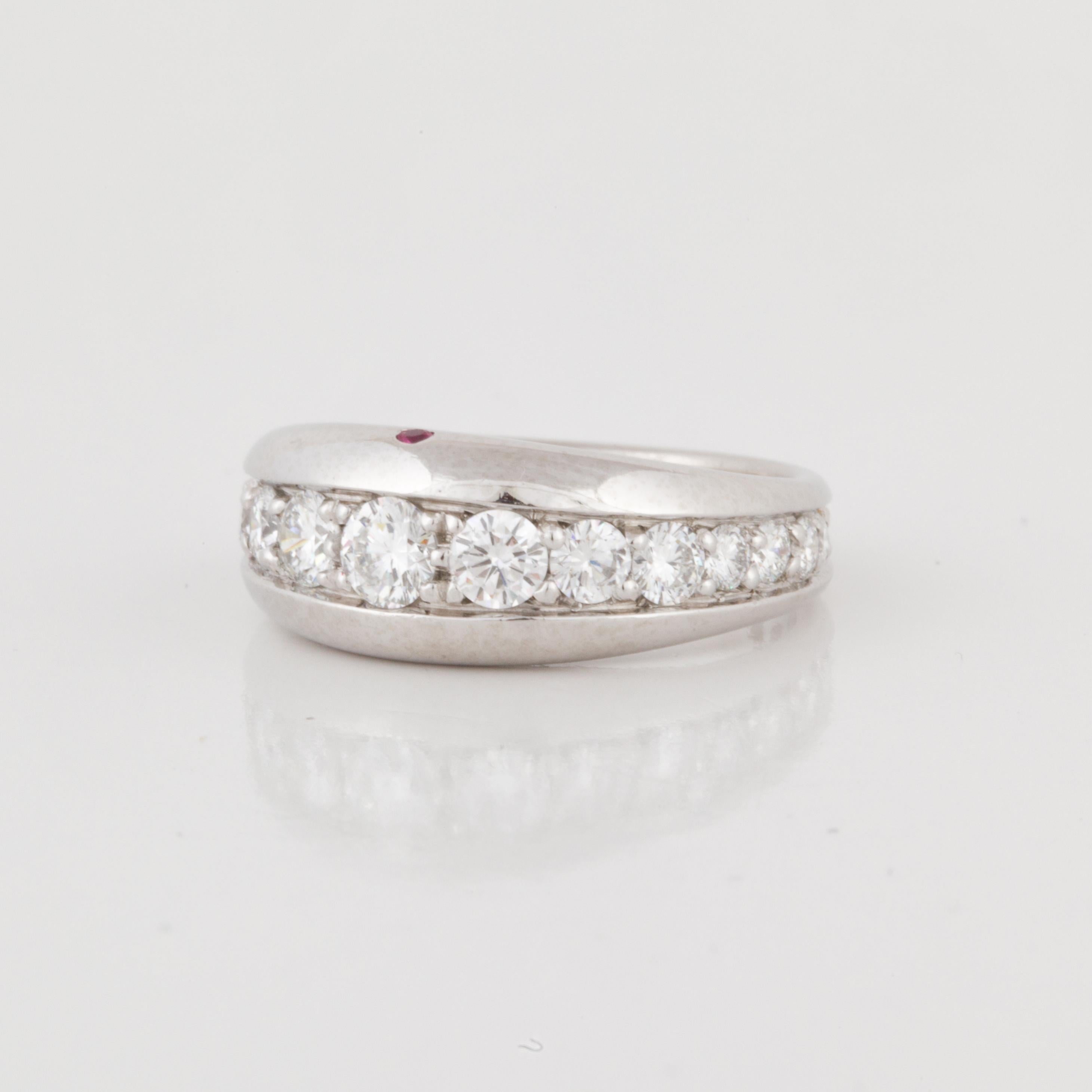 Varma band composed of platinum with round diamonds.  The ring is marked 