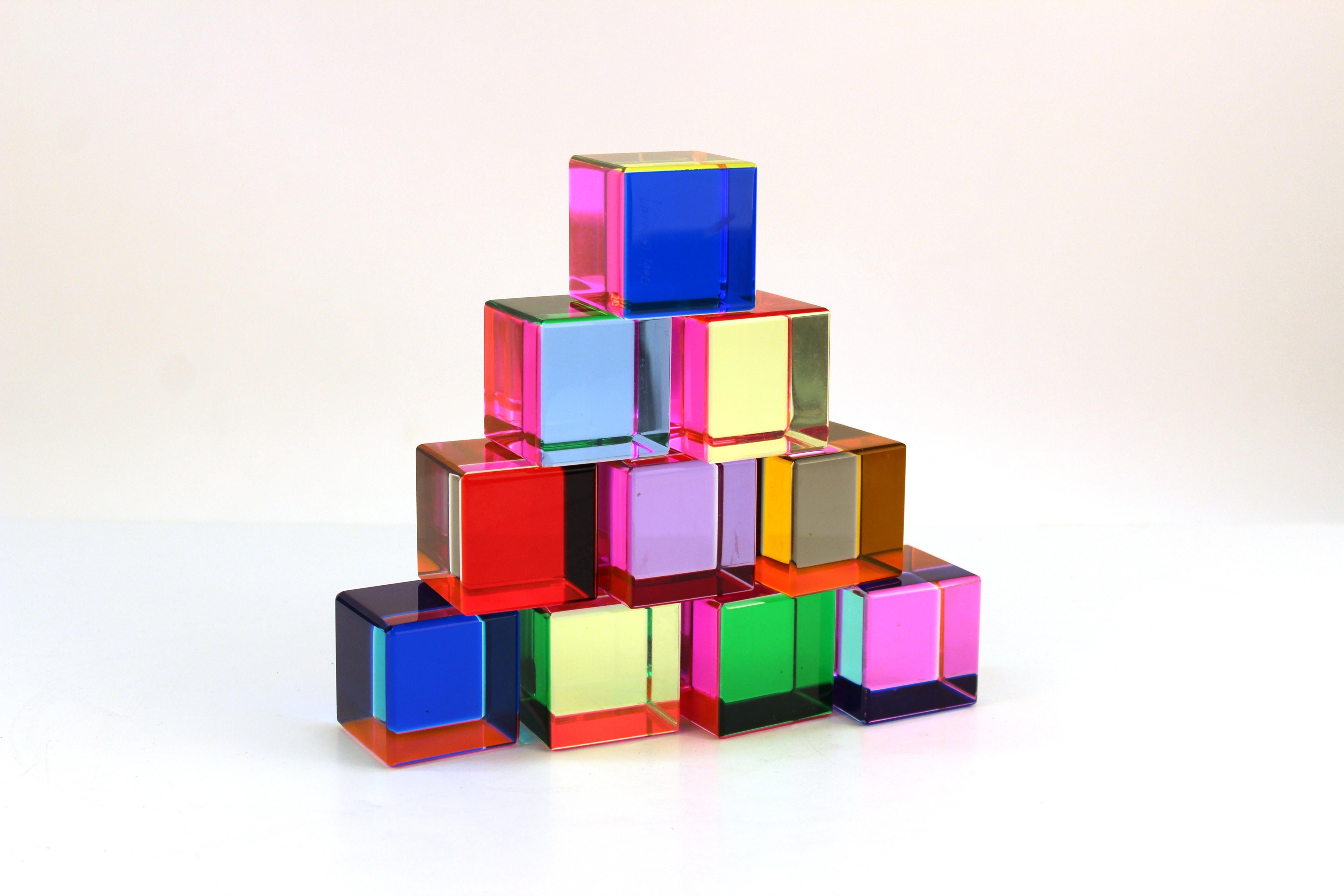 Vasa Mihich set of ten cubes crafted out of multicolored acrylic. Each cube side features a different sheer neon color allowing the colors to change and mix depending how the sculptures are placed. One cube is signed and dated 1990. Despite a tiny