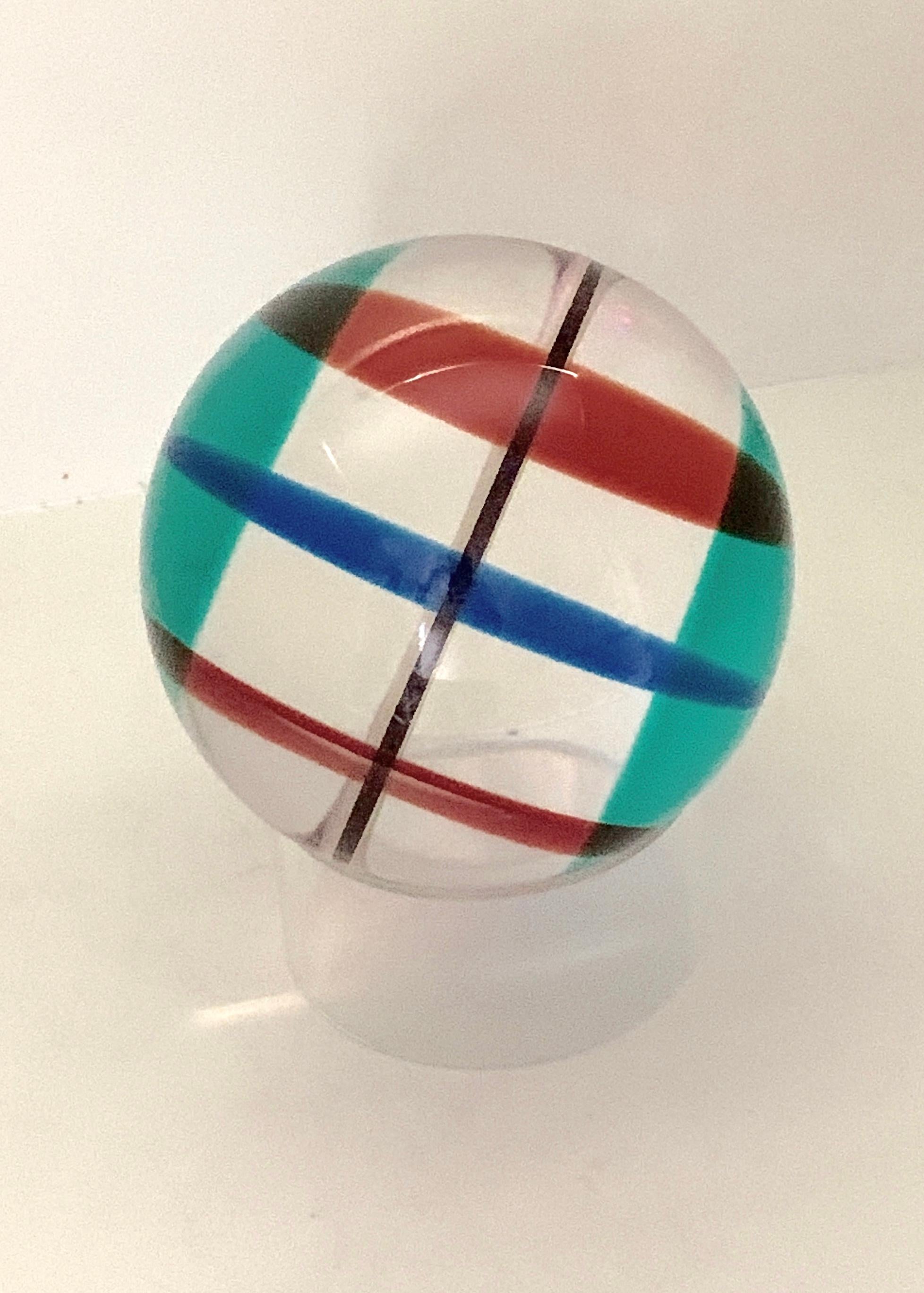 A 1997 signed Vasa Mihich multicolored sphere. It rests on a simple circle acrylic piece. This sphere is difficult to photograph and we have presented it with flash and without. It is in good age appropriate condition with some surface
