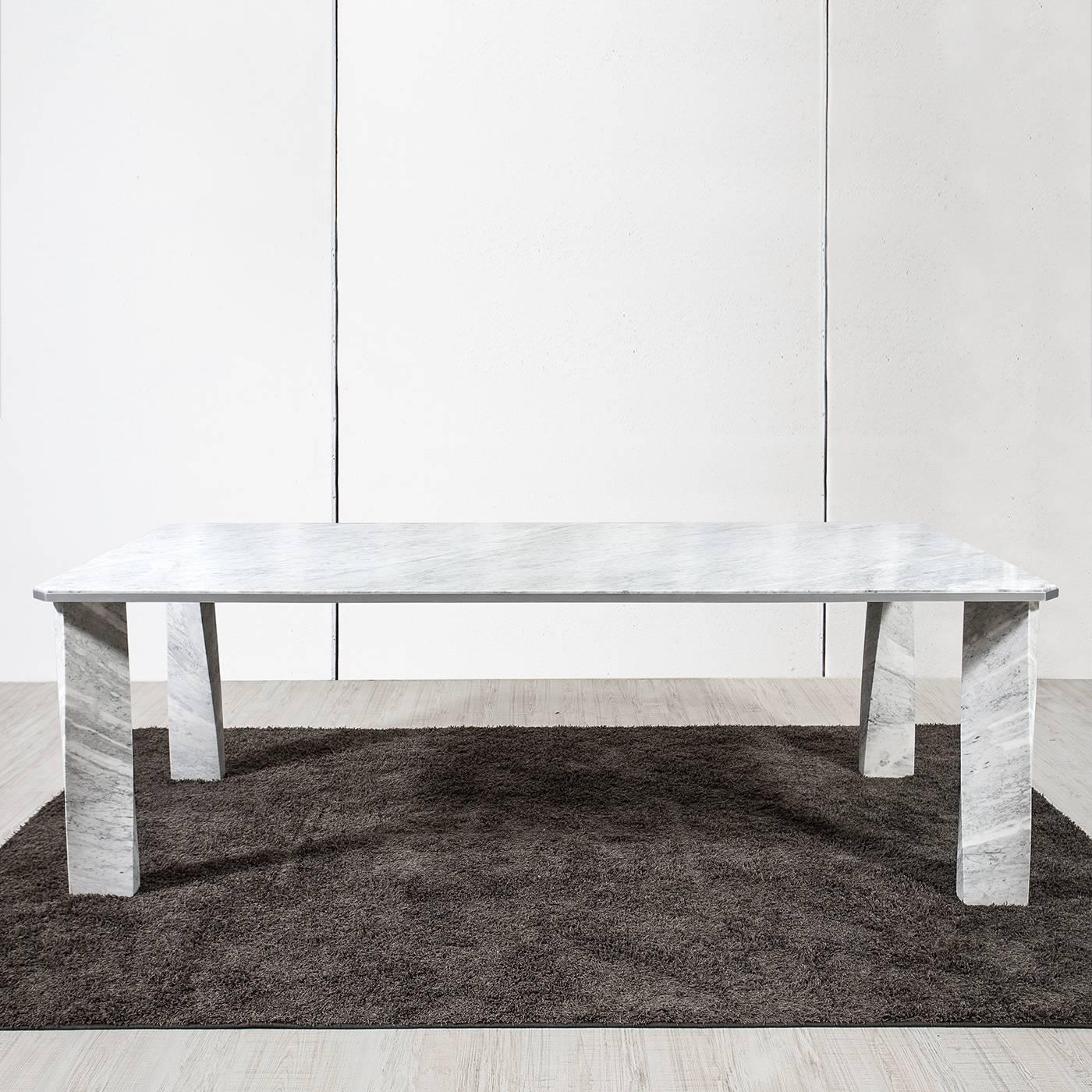 A timeless addition to both a Classic and contemporary dining room, this magnificent table was crafted entirely of precious Carrara marble whose white color and one of a kind veins add a striking accent to its unique structure made of a rectangular