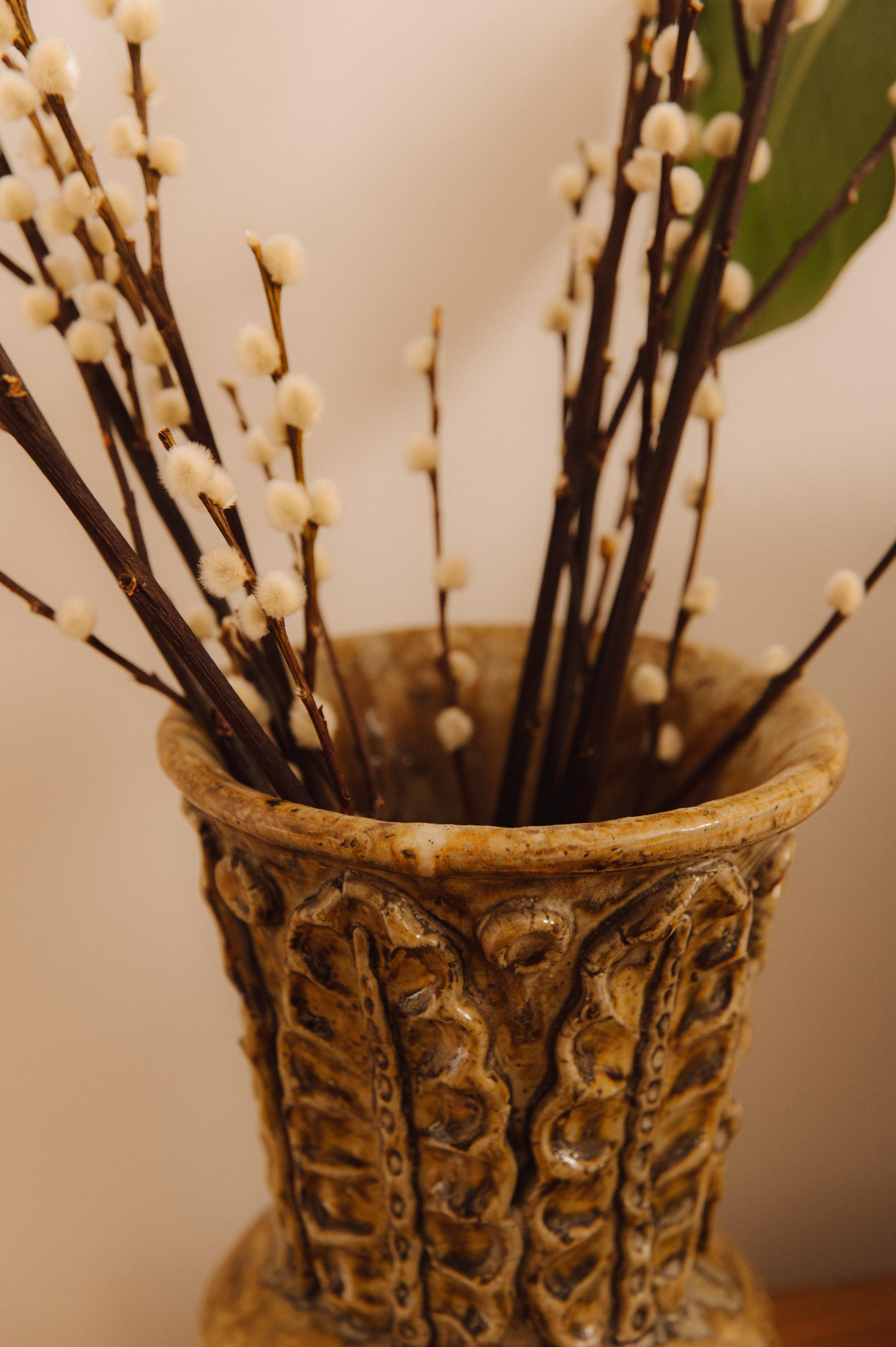 This unique ceramic vase by French ceramist André Rozay perfectly embodies the organic and textured style for which the artist is celebrated. Featuring raised motifs reminiscent of natural forms—such as leaves or botanical elements—the piece