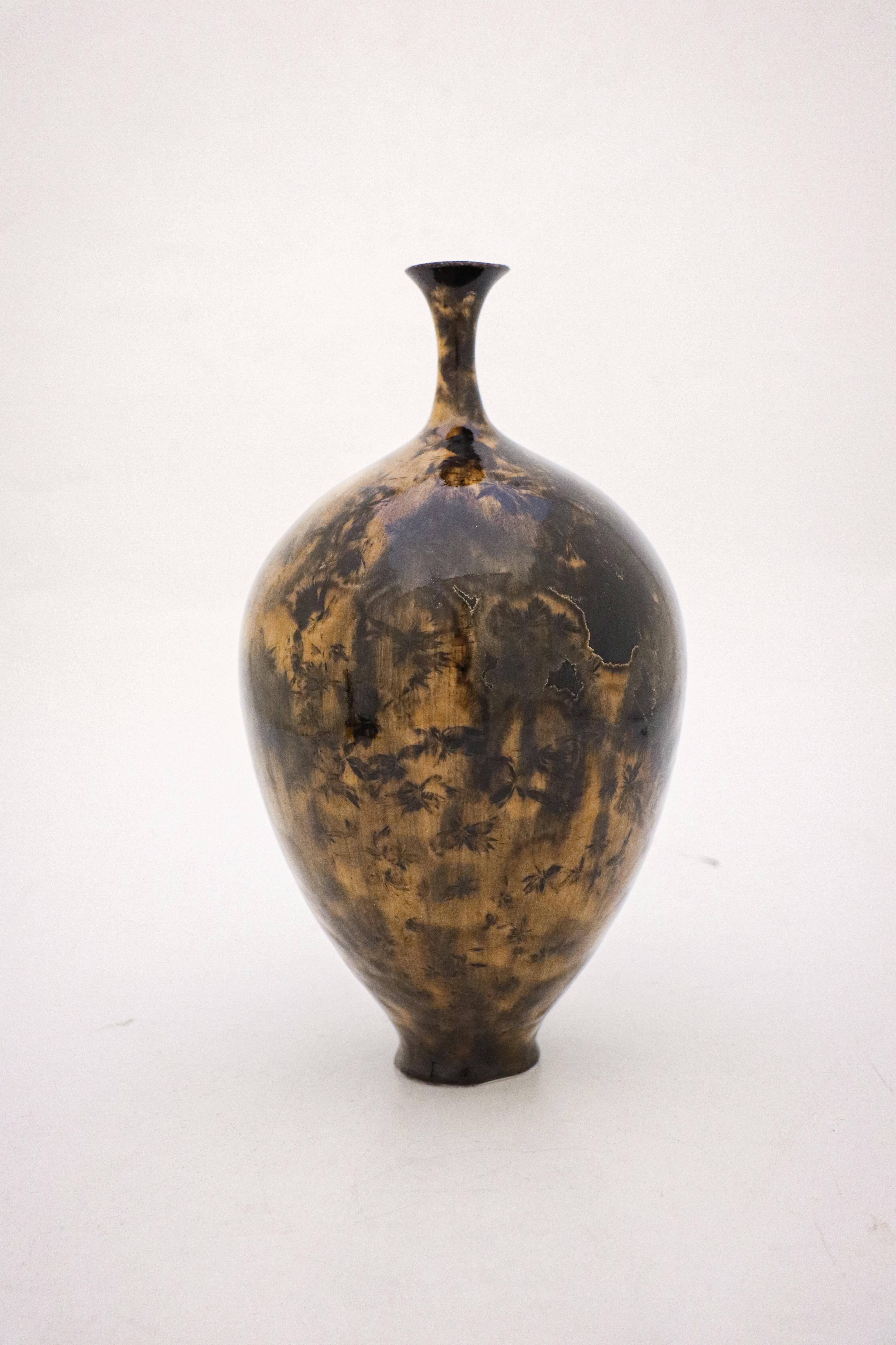 A unique vase in a black & brown color with a lighter brown crystalline glaze created by the contemporary Swedish artist Isak Isaksson in his own studio. The vase is 24.5 cm (9.8