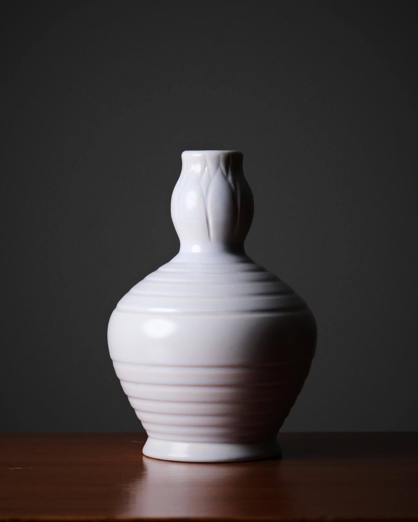 Swedish vase by Allan Ebeling for Bo Fajans, produced in the 1930s. A refined form typical of early Swedish modern ceramics.

The piece features a beautiful, light blue glaze that highlights the vessel’s elegant silhouette and subtle hand-thrown