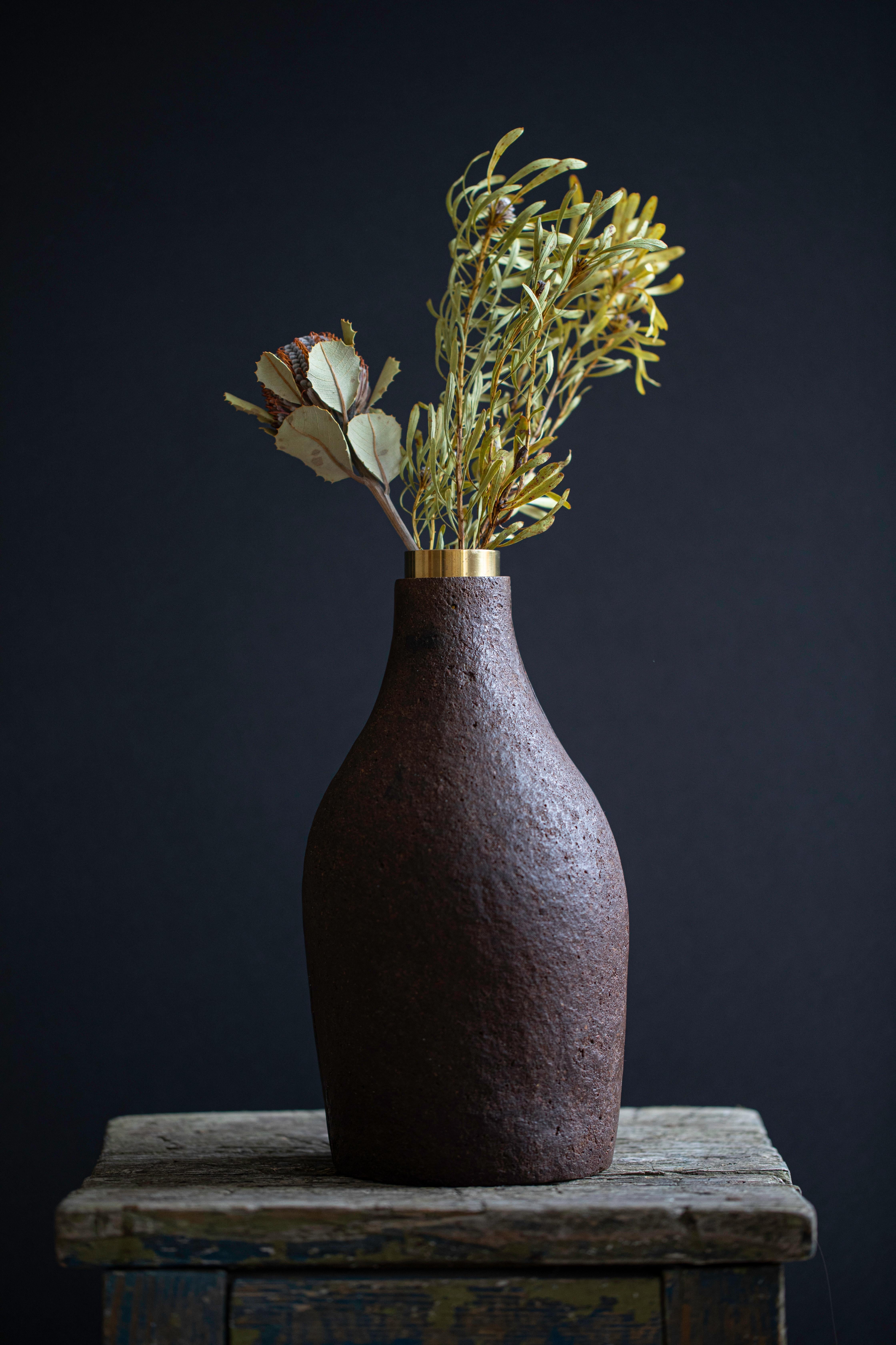 Vase by Evelina Kudabaite Studio
Handmade
Materials: oak, brass
Dimensions: H 260 mm x D 120 mm
Colour: dark brown
Notes: for indoor use

Since 2015, product designer Evelina Kudabaite keeps on developing and making GIRIA objects. Designer