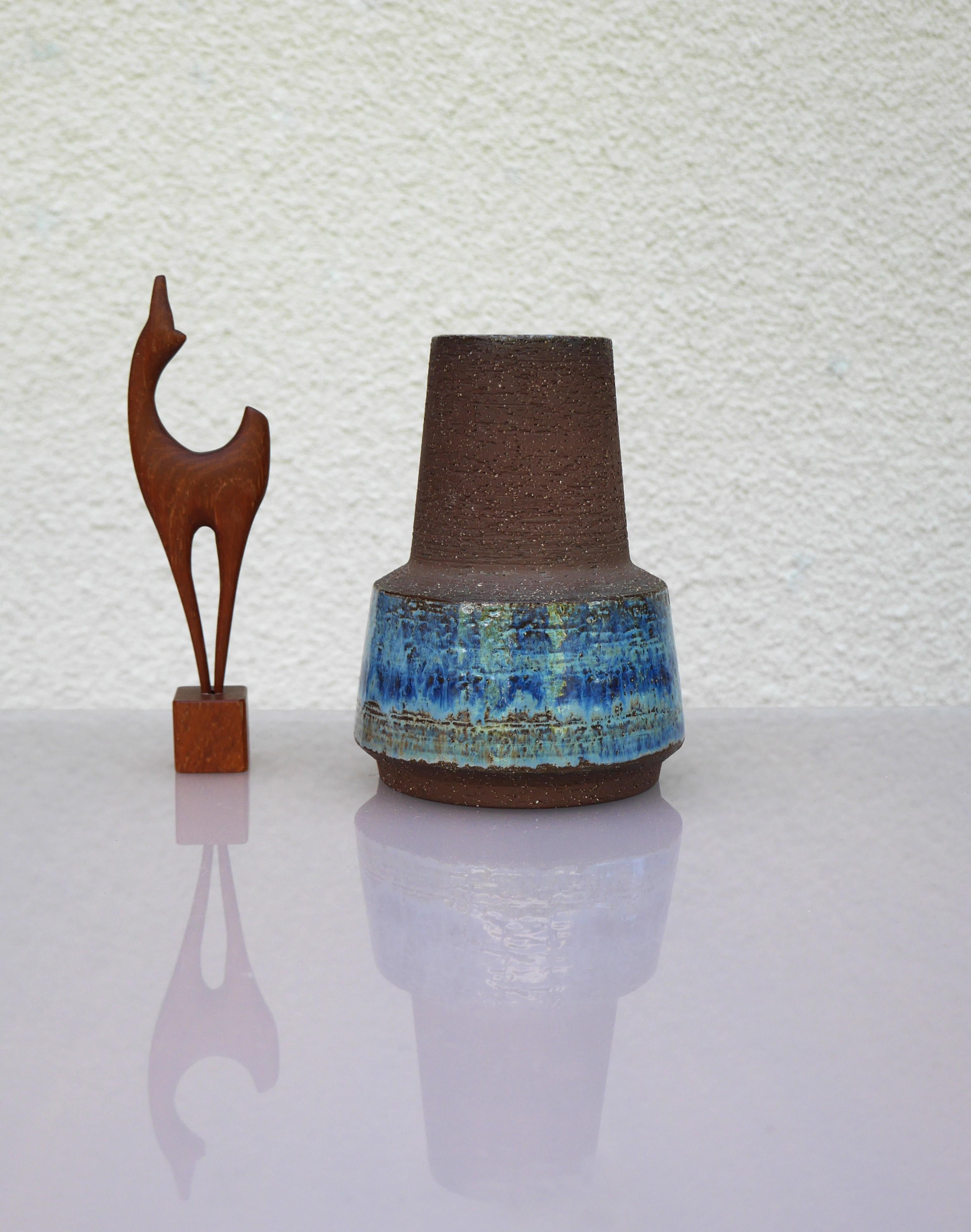 Uno splendido vaso realizzato da Micheal Andersen per Bornholm ceramics in Danimarca. Argilla pesante e ruvida con uno smalto blu sul fondo e sul bordo del pezzo. Questo vaso fa parte di una serie dello stesso stile che presentava molte varianti
