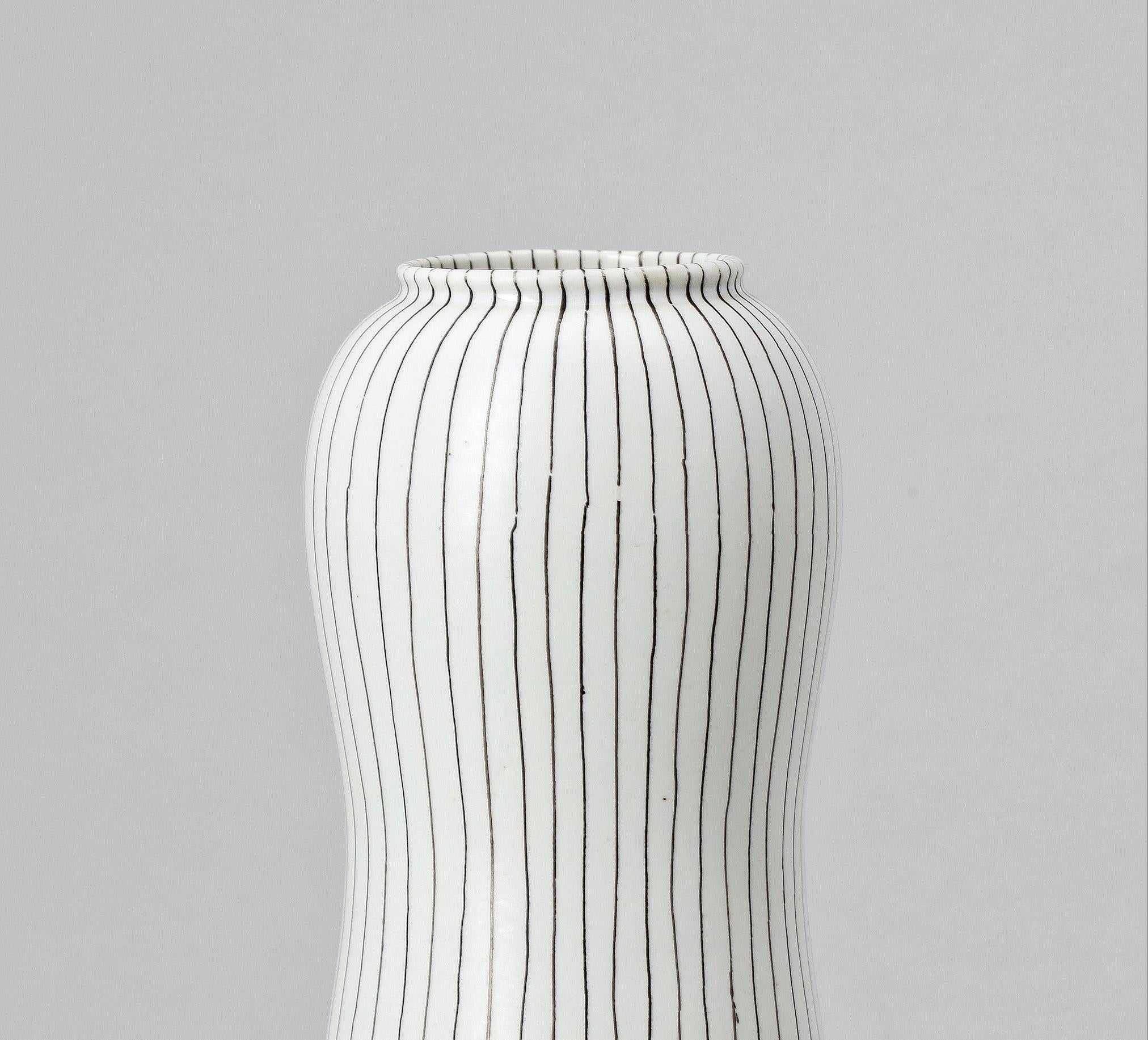 Stig Lindberg (1951) Filigran vase for Gustavsberg Ceramic and silver 
Stig Lindberg’s ”Filigran” (Filigree) series was designed in 1951 during the golden era of Swedish pottery. The works of art were made of stoneware with streamlined shapes,