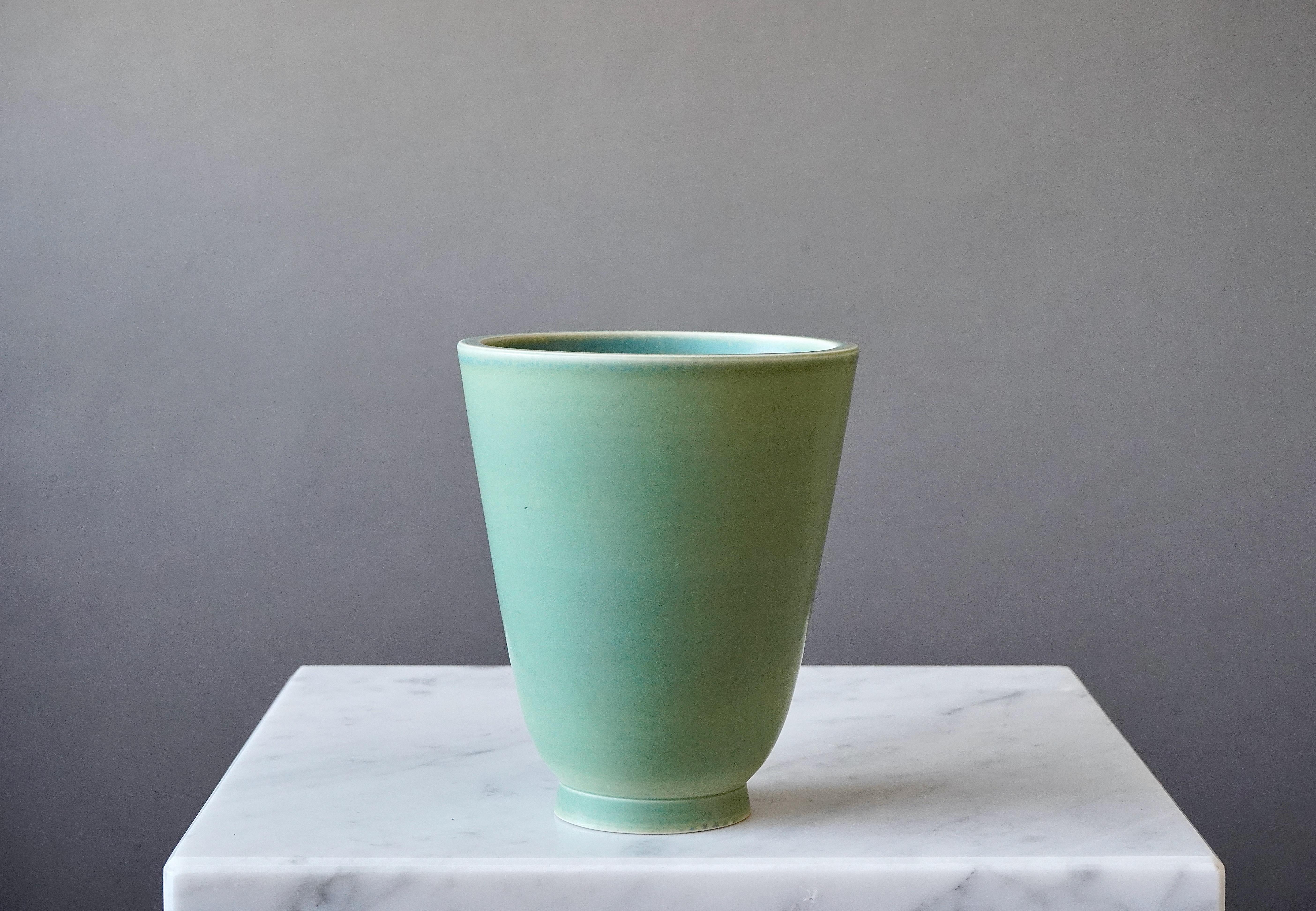 Beautiful vase made by Wilhelm Kåge at Gustavsberg Studio in Sweden, 1940s. 

Celadon glazed stoneware.

Excellent condition. Impressed 'Gustavsberg / CELADON / KÅGE / HANDDREJAD'.

Wilhelm Kåge was a Swedish artist, painter, and ceramicist.