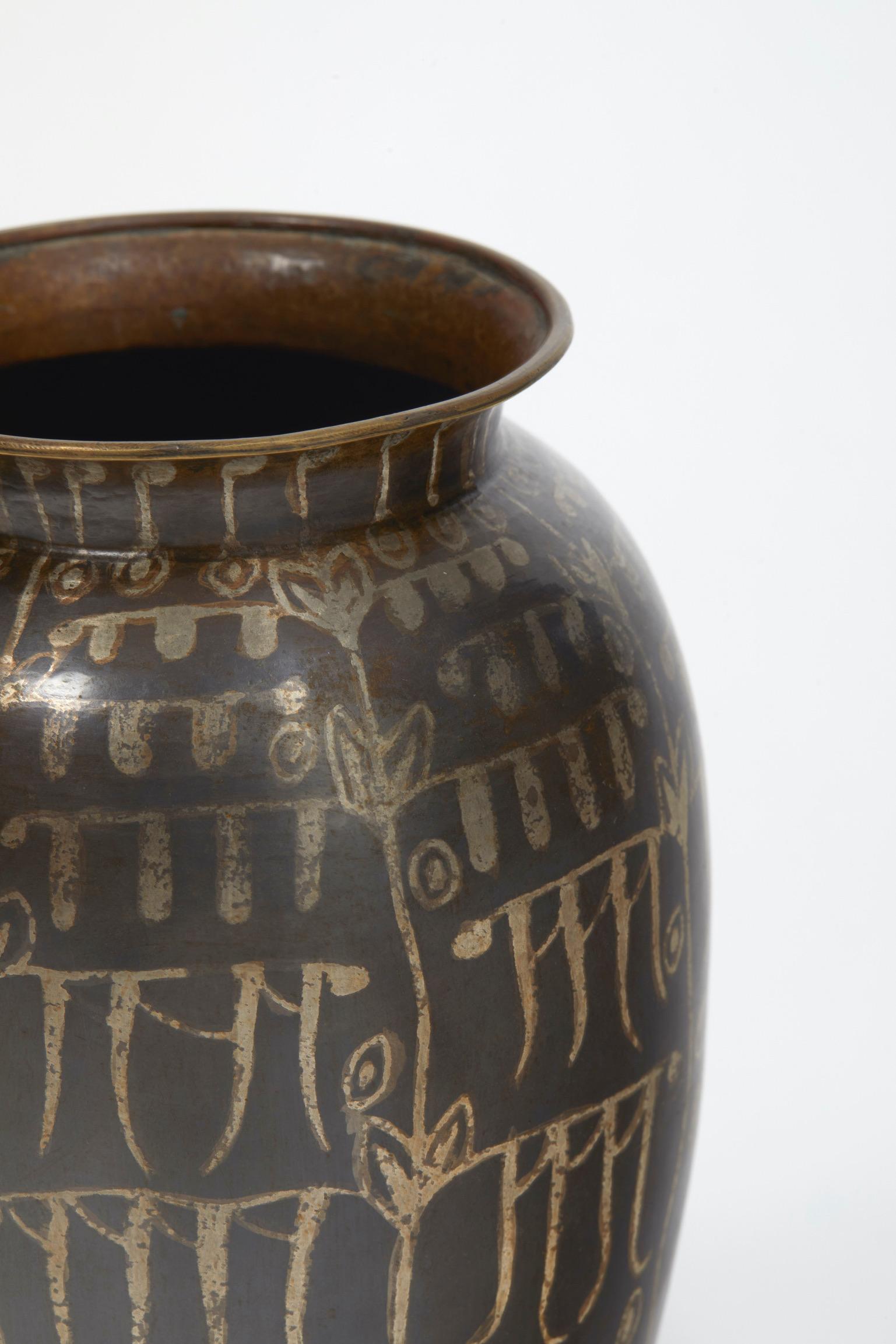 Brass dinanderie ovoid vase with stylized vegetal decoration with silver patina on a plain brown background. 
Signed 