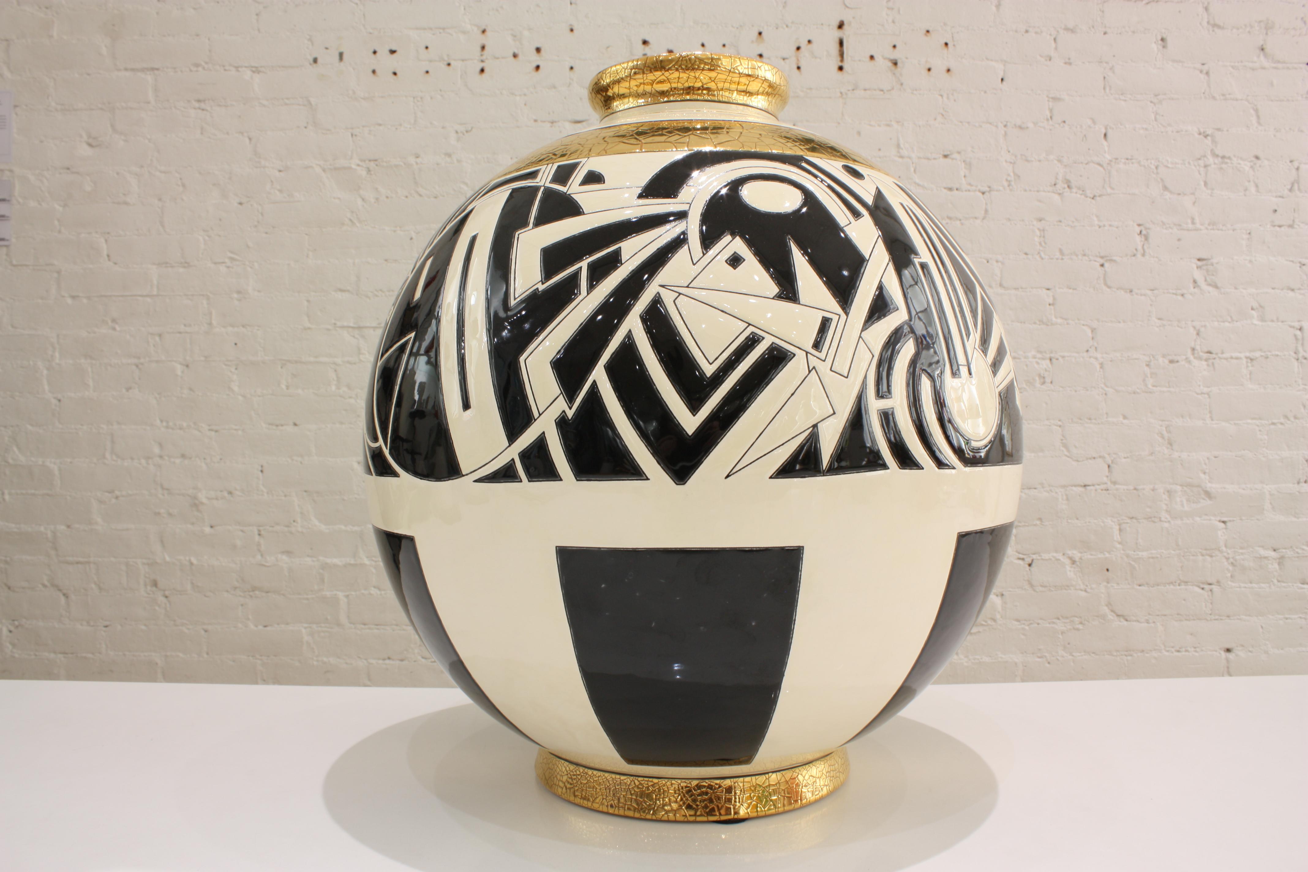 Superb round vase in limited edition in Art Deco style. The artist Nicolas Blandin was commissioned by Les Emaux de Longwy to create this graphic design for their world famous Boule vases. Black and ivory tones highlighted by crackled gold leaf give