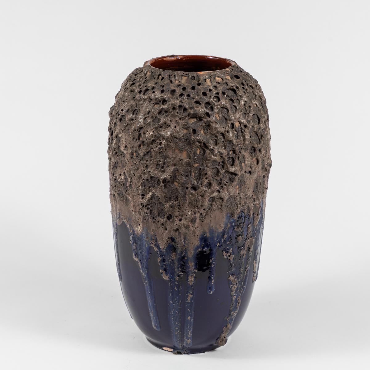 A blue and brown pottery vase.