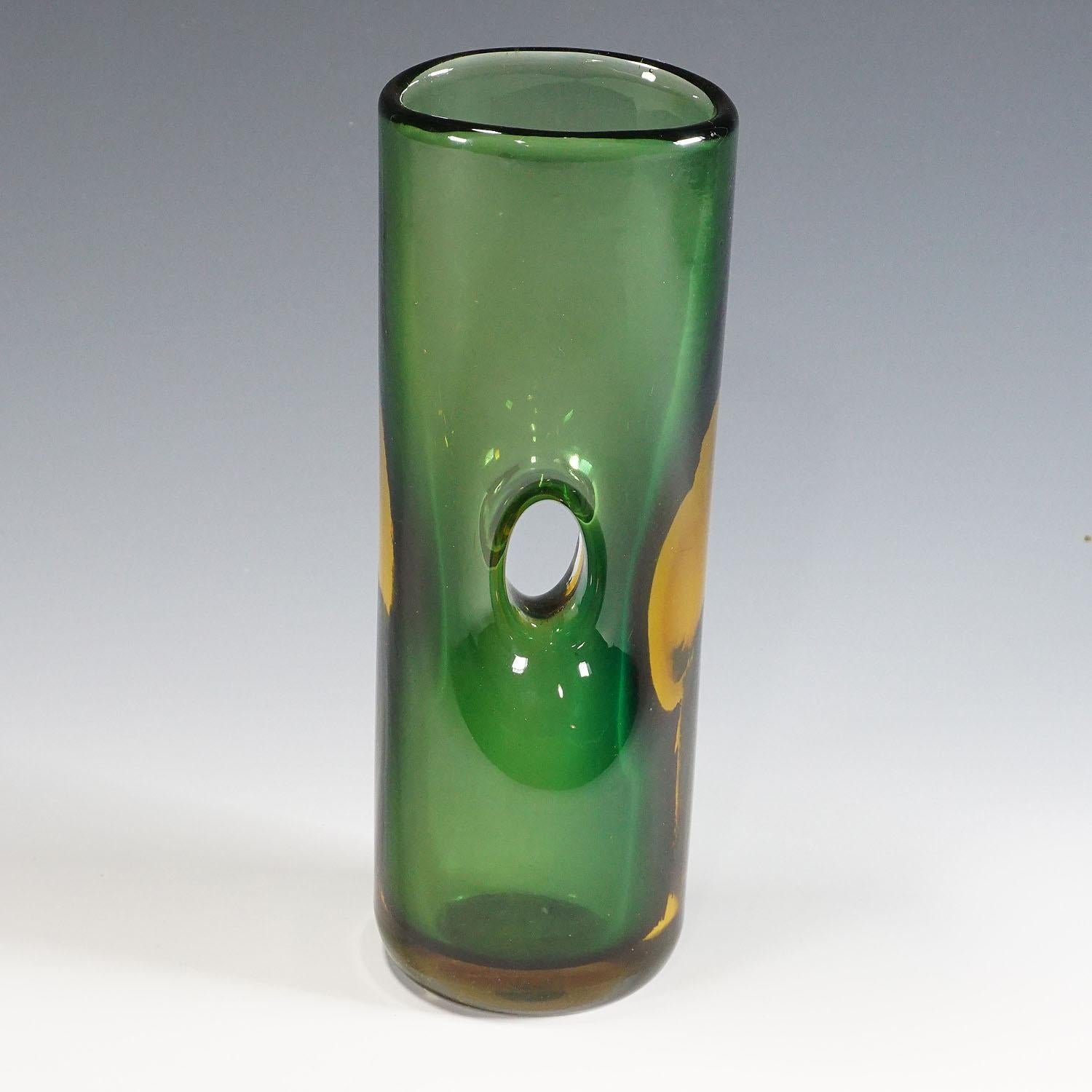 Tan France Auction Pick

A Forato vase in green, and amber colored glass designed by Fulvio Bianconi in 1951, manufactured by Venini, Venice, Italy ca. 1950s. The artglass is with etched signature 'venini murano italia' on the base. There are traces