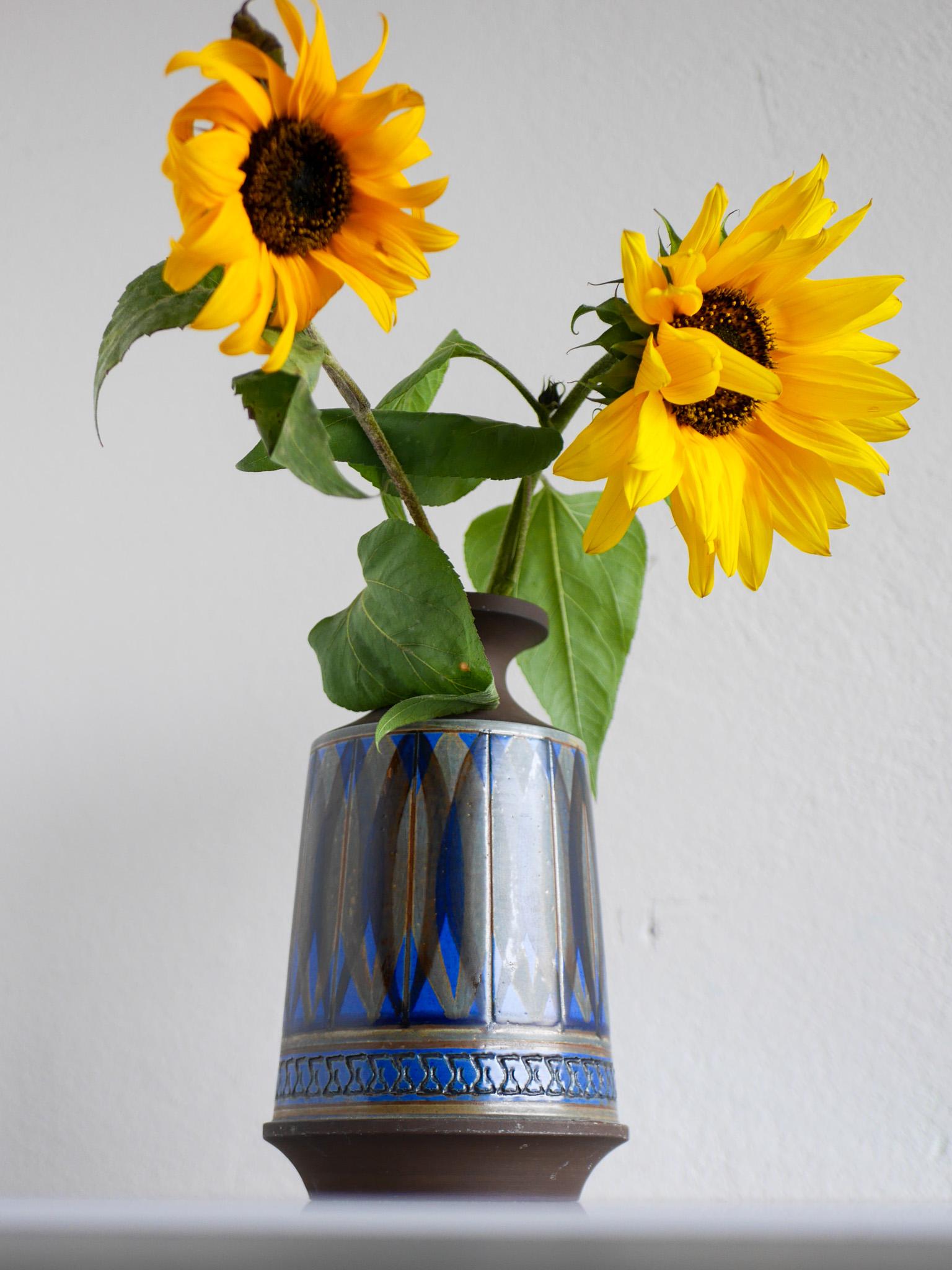 This is a stunning  stoneware vase from Alingsås keramik, Sweden. It is handmade by Ullah Winbladh and signed by her. The pattern and the glazing is just amazing and so typical of her work. The colors are pale green and  bright blue in various