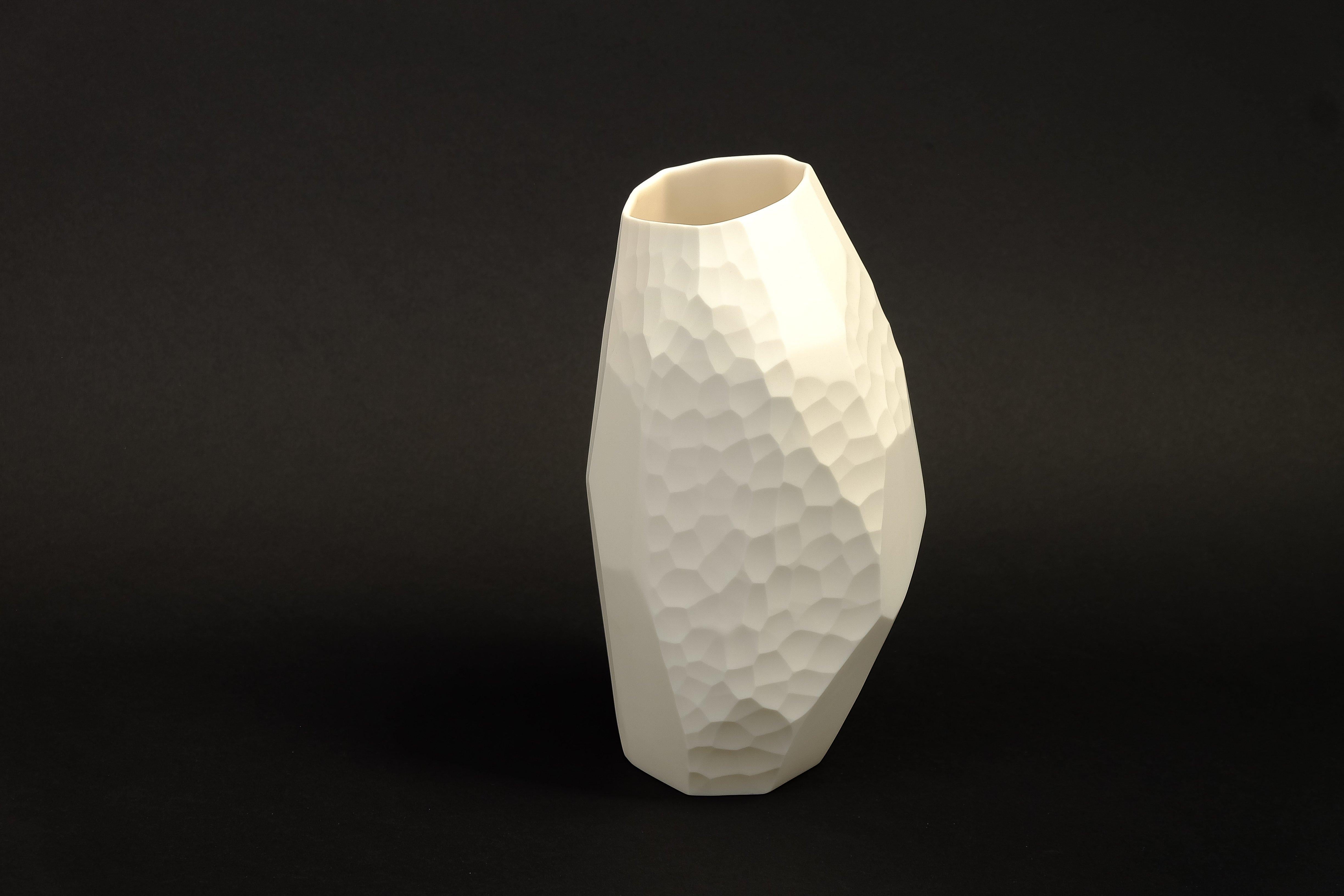 A clear glass vase blown and engraved by design duo Vezzini & Chen.

Vezzini & Chen’s work is defined by the artful marriage of hand carved ceramics and blown glass. The collections tread a fine line between functional and conceptual, with the