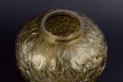 Vase in amber-coloured glass with deeply moulded relief. France, mid-20th C.