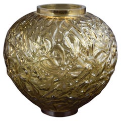 Vase in amber-coloured glass with deeply moulded relief. France, mid-20th C.