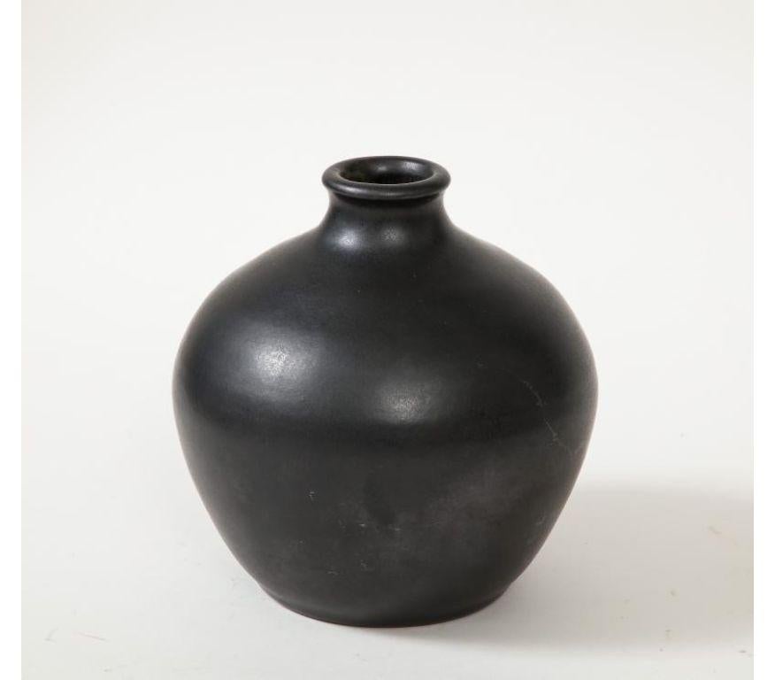 Glazed ceramic vase. Minimalist, simple shape with a small lip at the opening.

