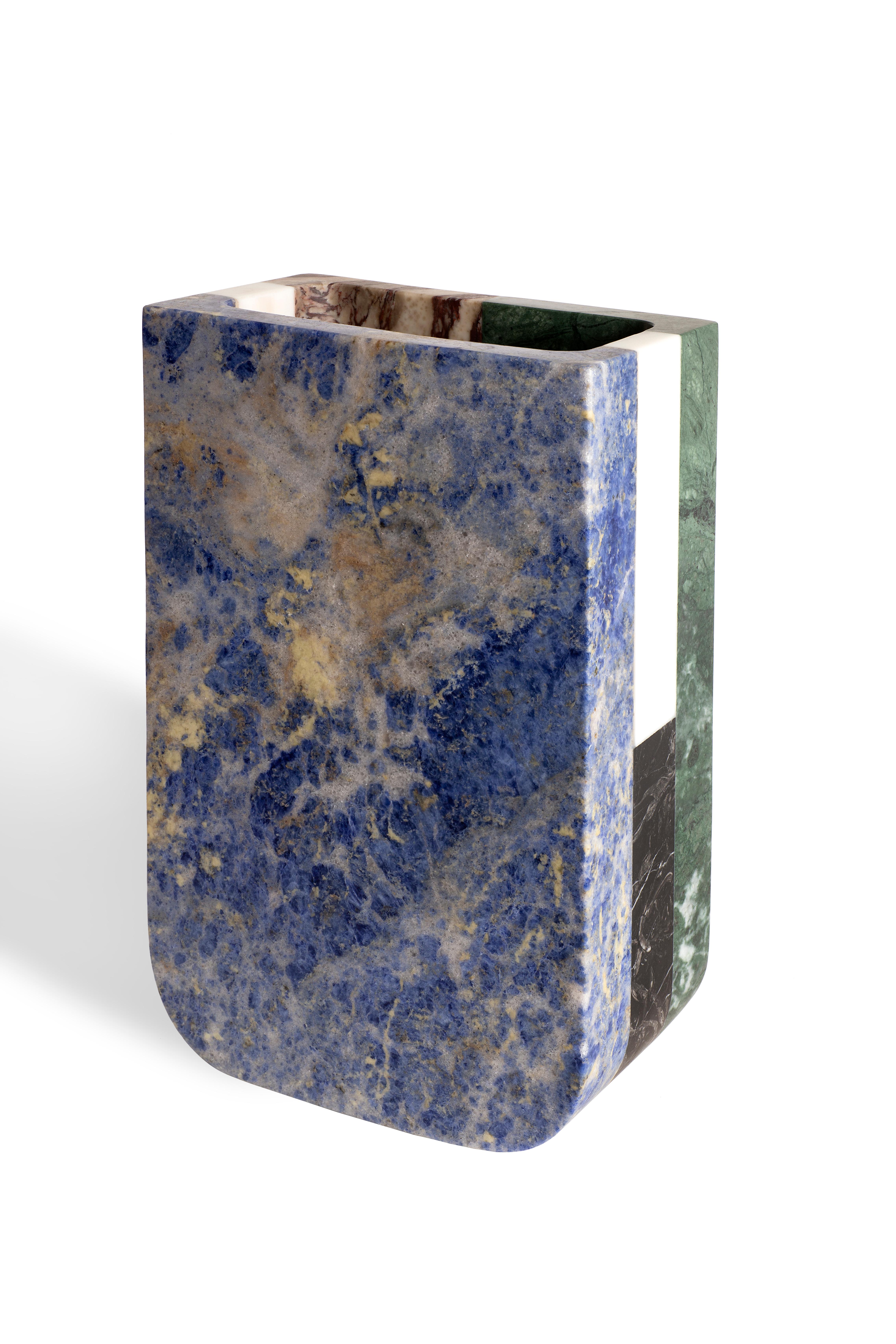 Vase in Black Marquinia, White Michelangelo, Arabescato Vagli Filo Rosso, Green Guatemala and Blu Sodalite marbles.
Size: 20 x 12 x 32 cm, 7.9 x 4.7 x 12.6 in, smooth finishing. Commercial name: Piero, Masters Collection by the Austrian designer