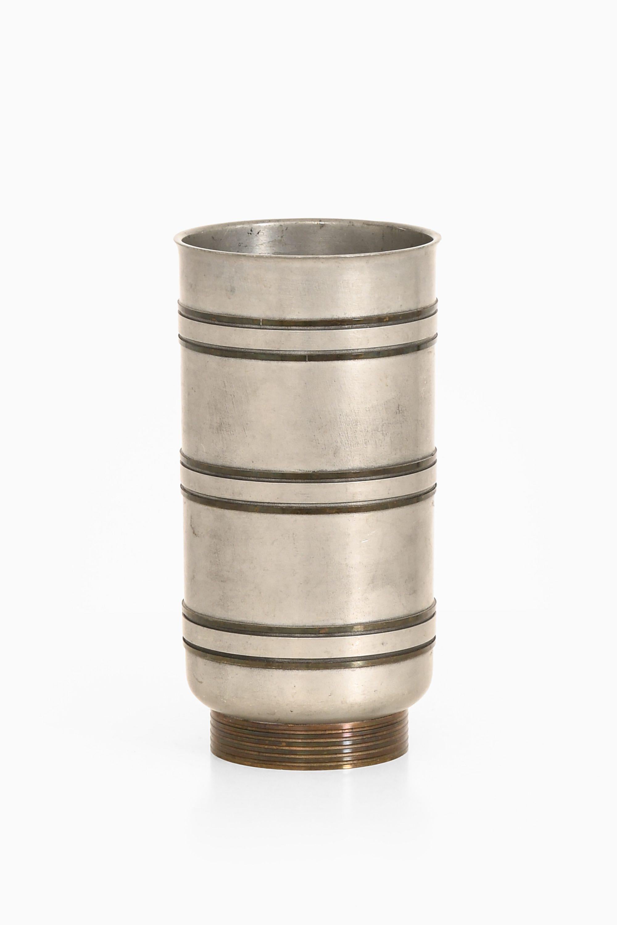 Vase in Pewter and Brass by Edvin Ollers, 1944

Additional Information:
Material: Pewter and brass
Style: Mid century, Scandinavian
Produced in Sweden
Dimensions (W x D x H): 10 x 10 x 20 cm
Condition: Good vintage condition, with small signs of