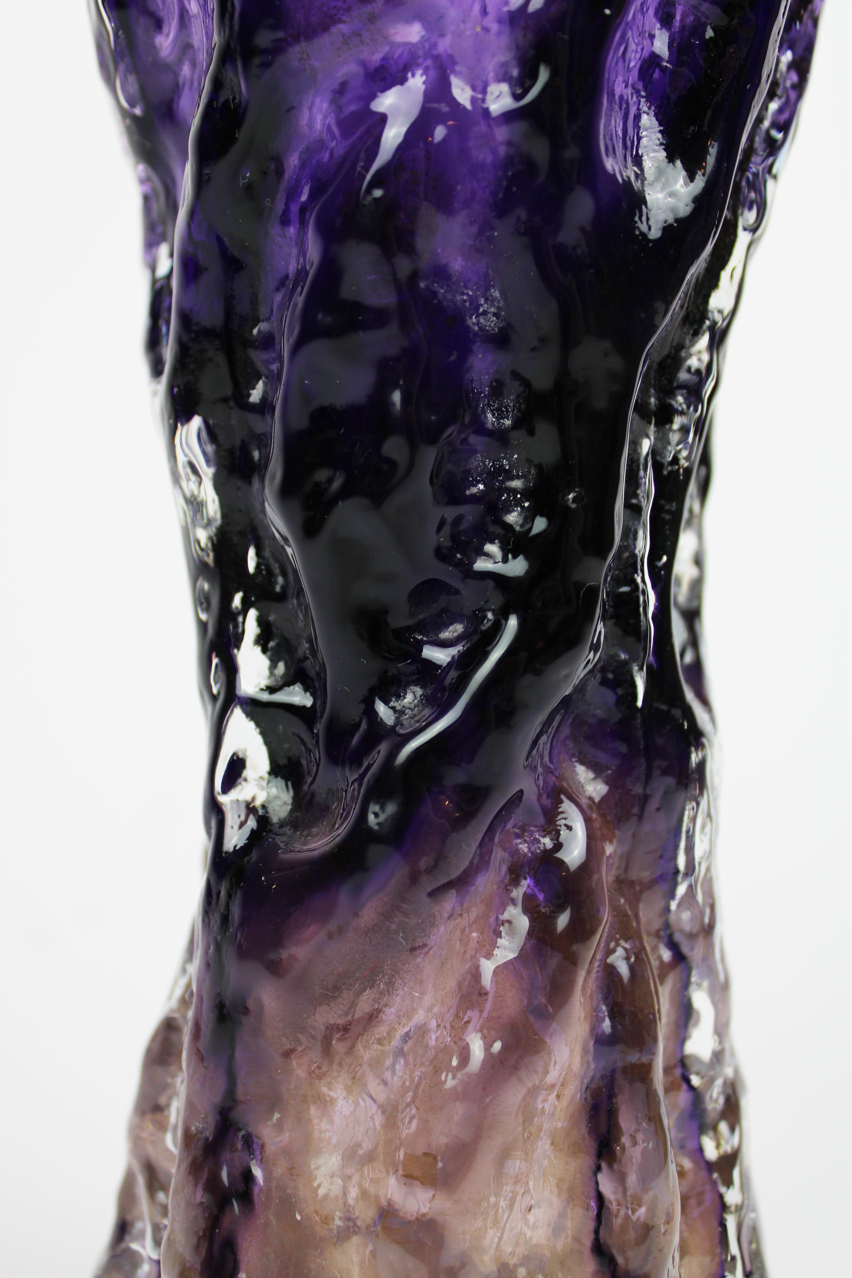 Presenting a stunning Ingrid glass vase from the renowned 'Rock Crystal' range, crafted in West Germany during the mid-20th century. This exquisite piece features a deep purple hue, adding a touch of elegance and sophistication to any