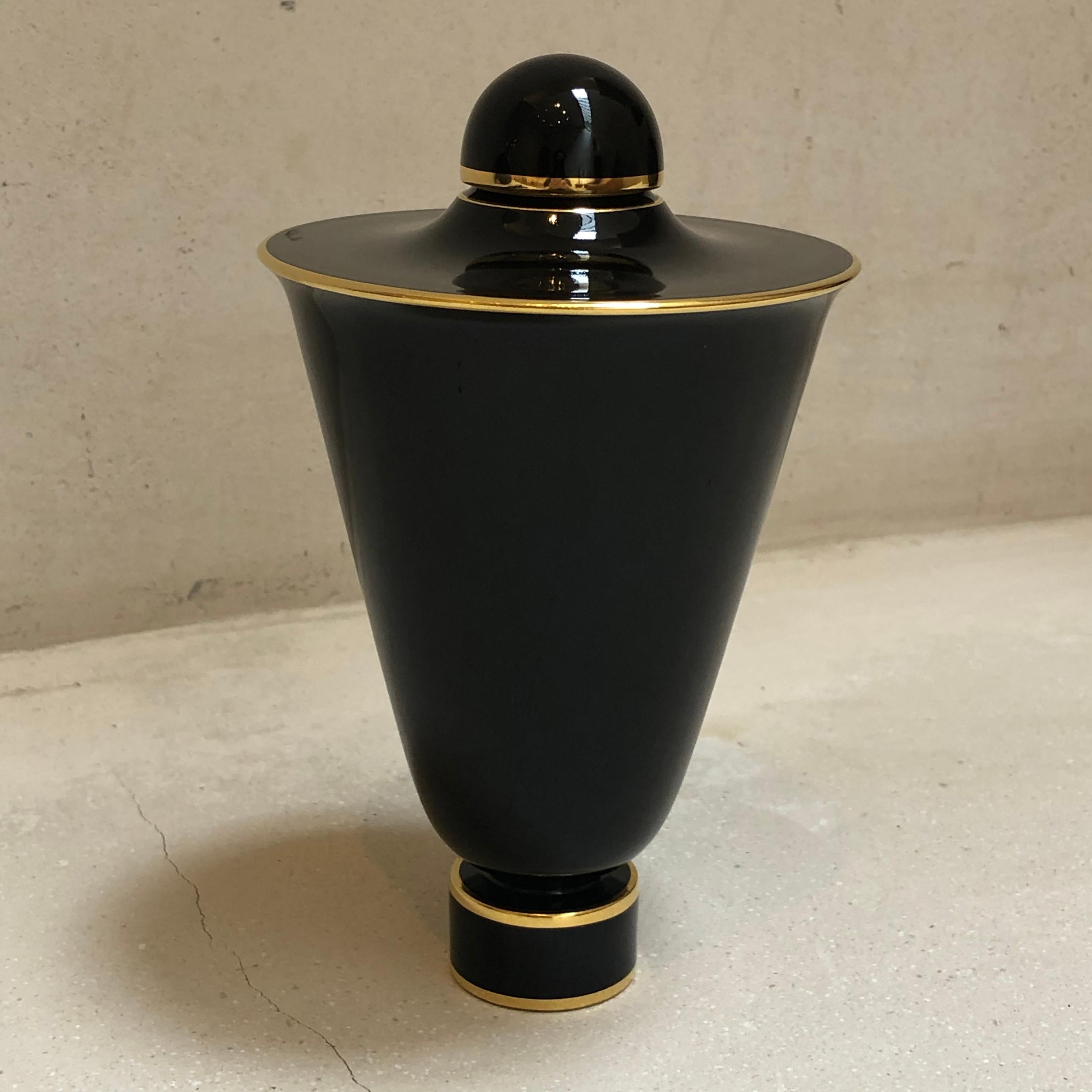 This vase was designed in the 1920s by Émile-Jacques Ruhlmann for the Manufacture Royale de Sèvres. The cone-shaped body of the vase is mounted on a circular foot hand-painted. The deep blue of Sèvres color pigments or glaze is brought out by the