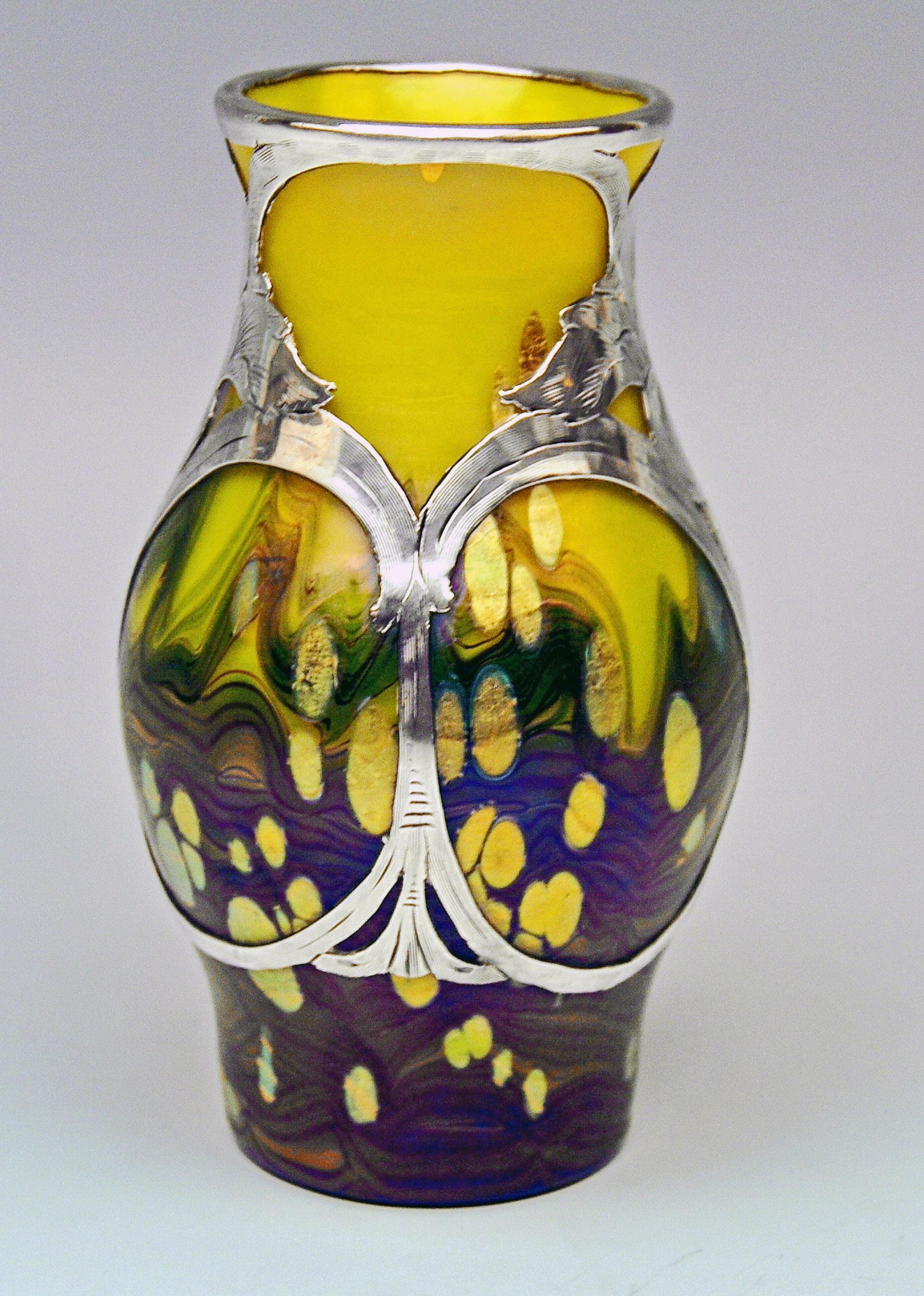 Vase Loetz (Lötz) Widow Klostermuehle Bohemia Art Nouveau 

Made by Loetz, Klostermuehle (Bohemia), circa 1902
Decor: Lemon Yellow Cytisus
 
It is a very interesting Loetz Art Nouveau Vase of bellied type.
The vase is made of colorless glass,