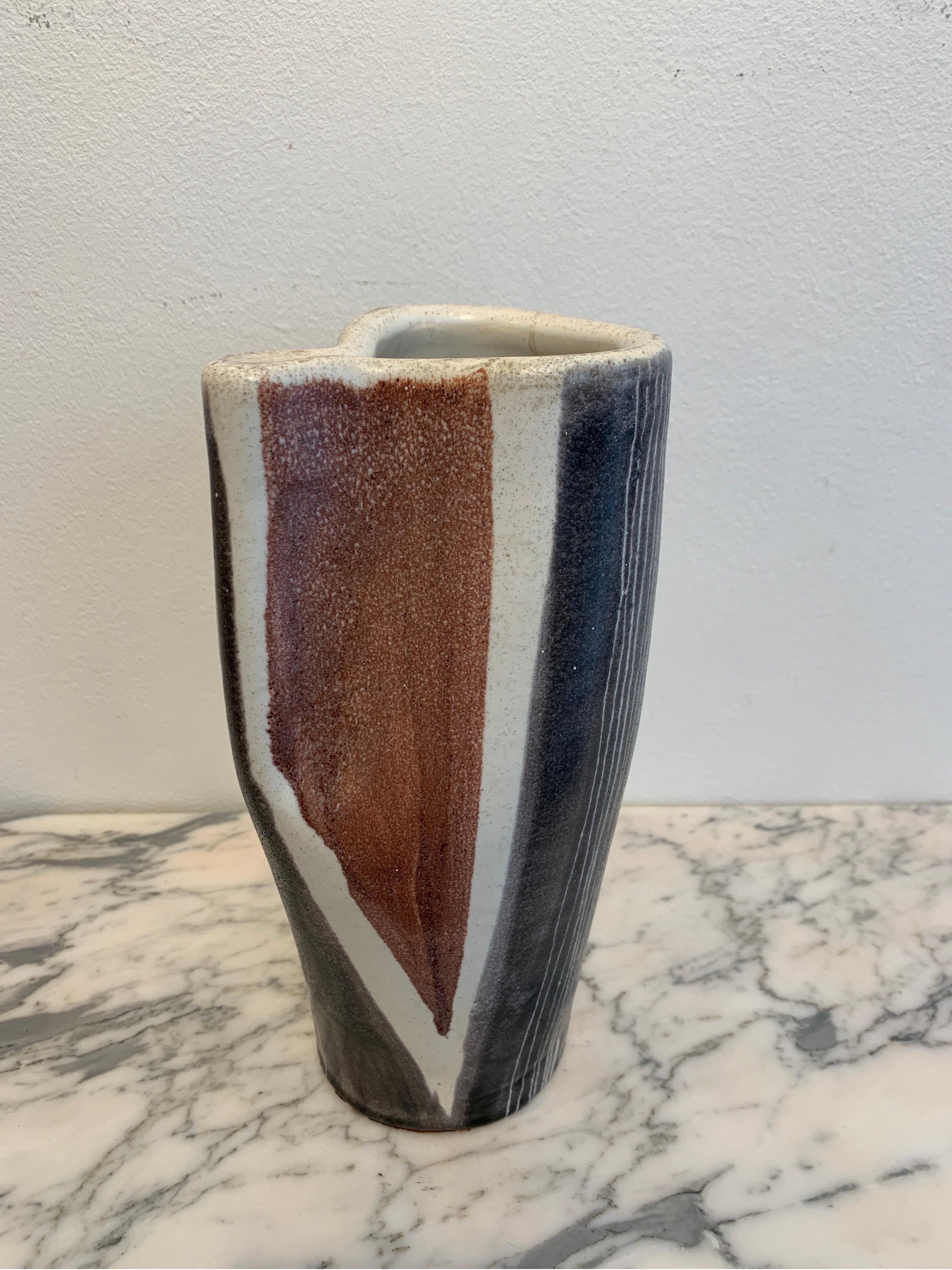 Mado Jolain is renown French Ceramist active in the 1950s. The present vase is made of earthenware enameled creamy. The decor is an abstraction in tones of black a brownish red. She is considered as one of the great names of the mid century modern