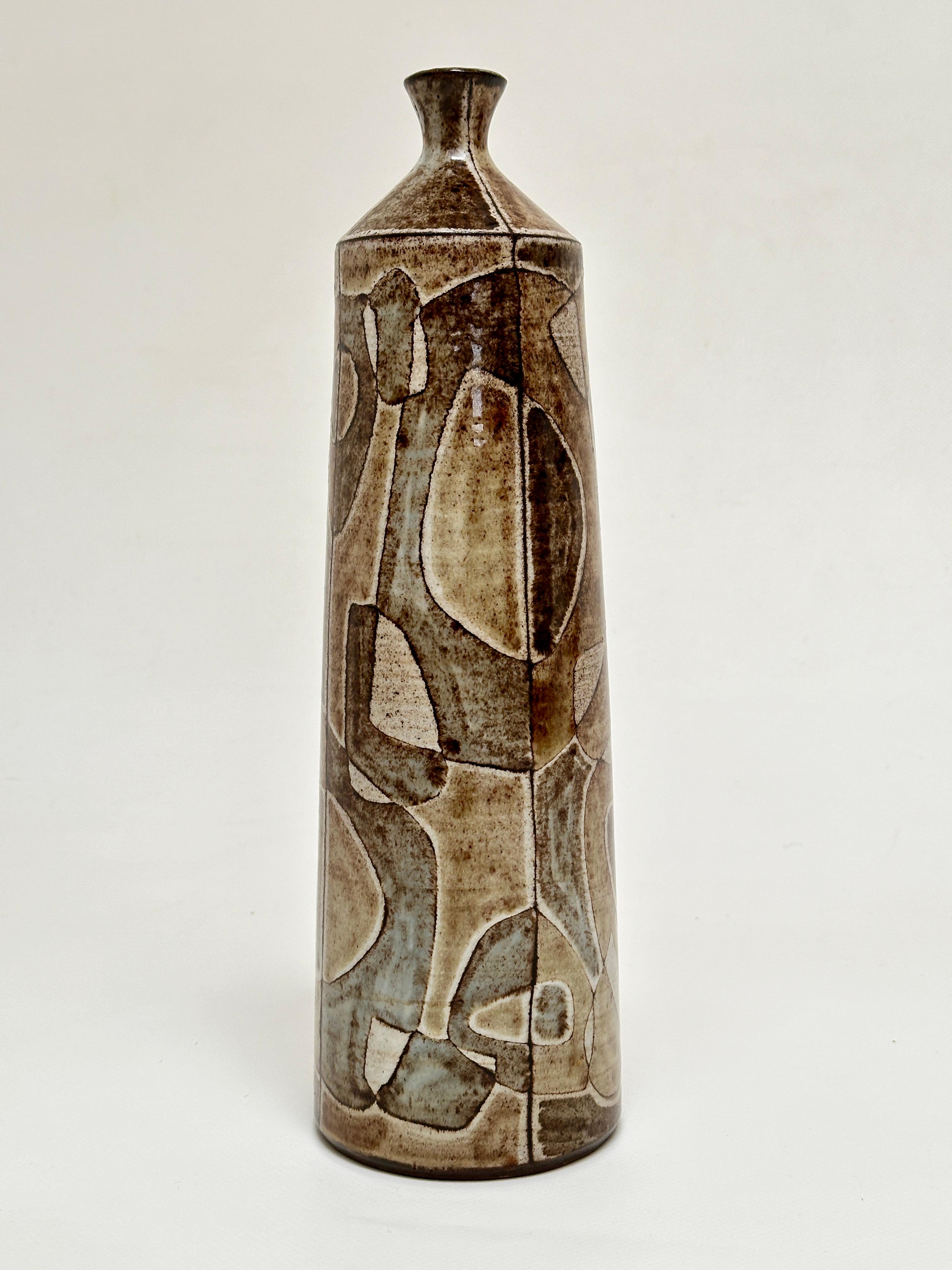 Elegant bottle vase in red earth from Vallauris, enamels with muted tones and abstract patterns revealing the earth through a transparent effect.

About the Artist 
Graduated from the Reims School of Fine Arts in the architecture section in 1949, he