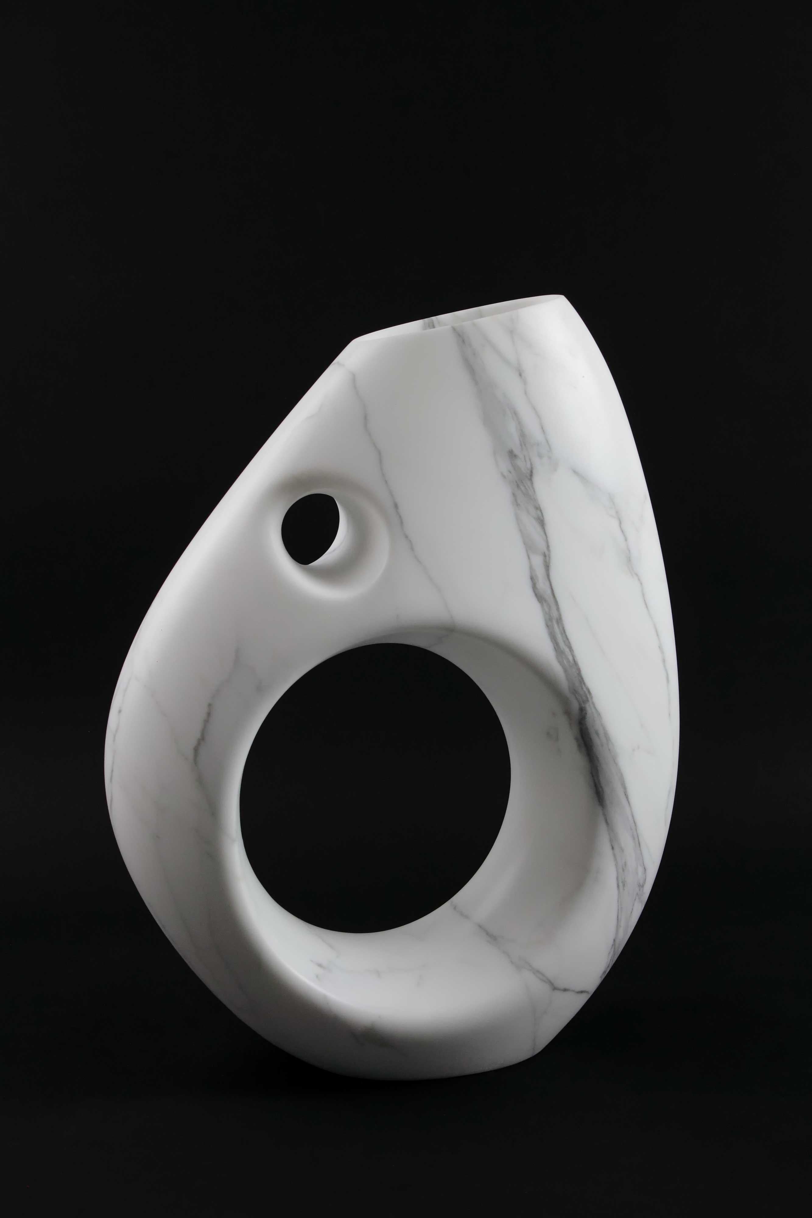 Important sculptural vase carved by hand from a solid block of Statuary marble.The precious white Statuary marble has always been the one preferred by sculptors and artists for their artworks. Known throughout the world, this beautiful marble has