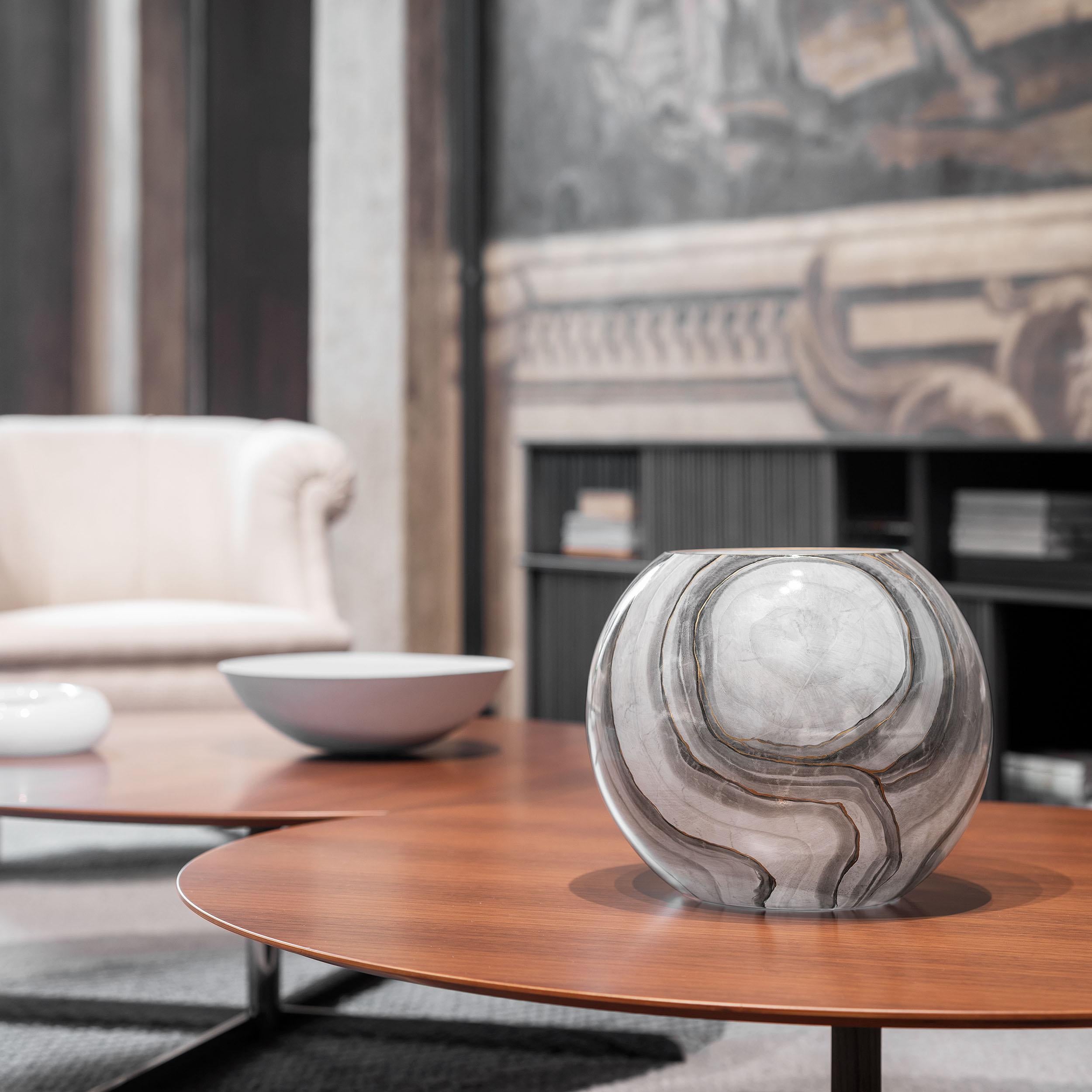 Add originality to your space with this vase crafted from hand-blown glass with a marbleized finish.