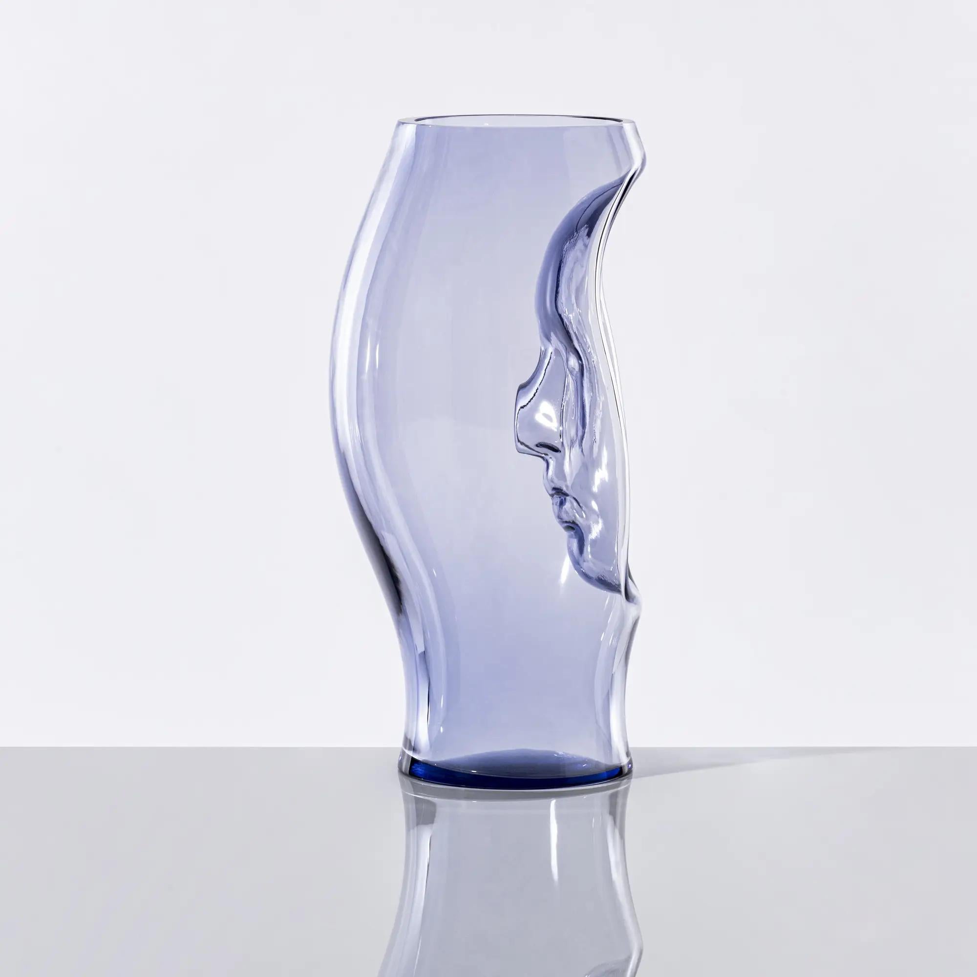 Venini - Murana Vase Mod. 030.57
Design: Fabio Novembre

The Murana vase features, at the heart of its elegant silhouette, a mask that evokes the rich iconography of the Venetian Carnival tradition - transforming a decorative object into a story of