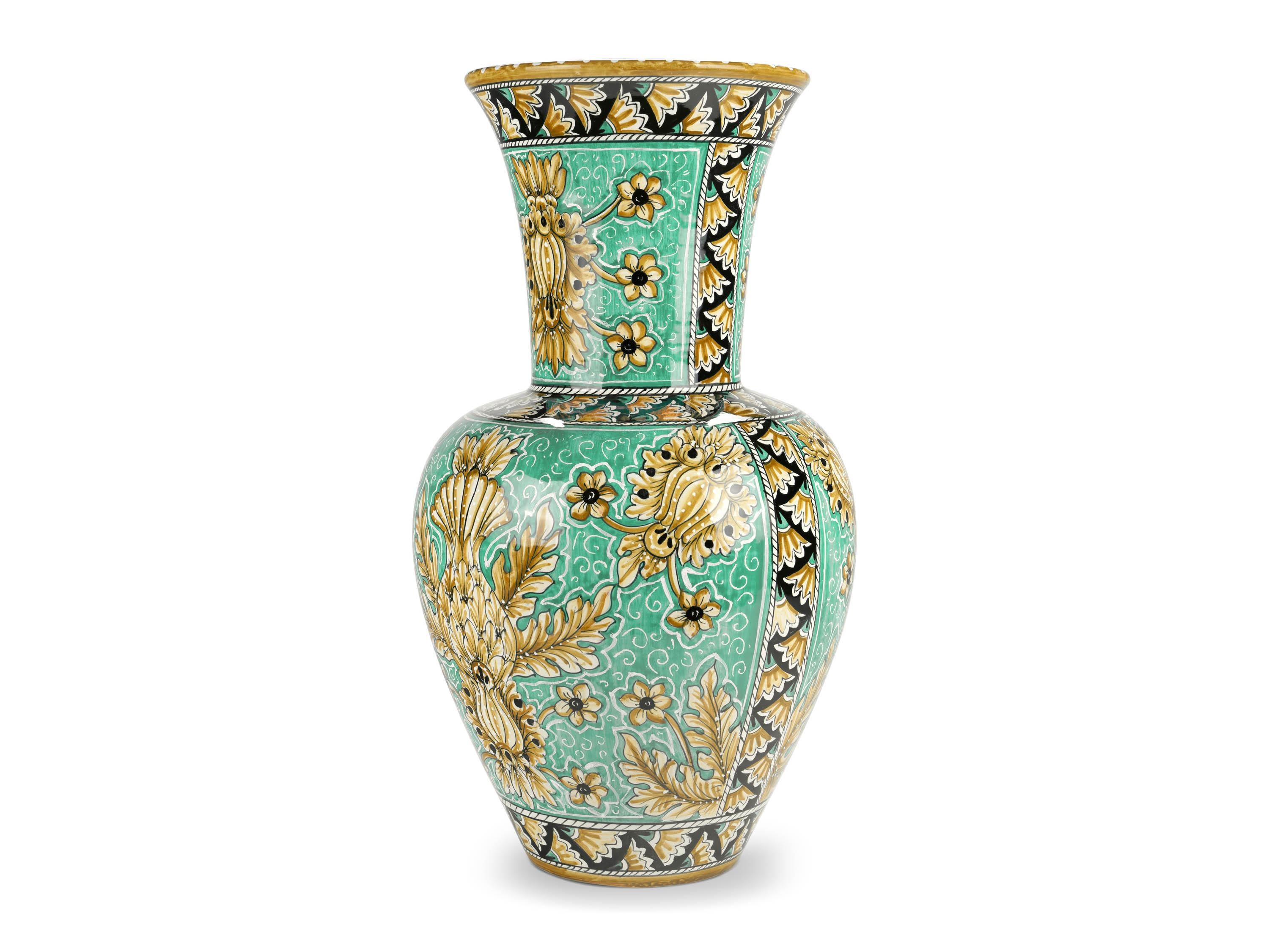 This lavish majolica vase is painted in polychrome, characterized by the elegant presence of naturalistic ornamental motifs that enhance its forms beautifully. Its powerful aesthetic impact is ensured by the slender neck and by the hand-painted