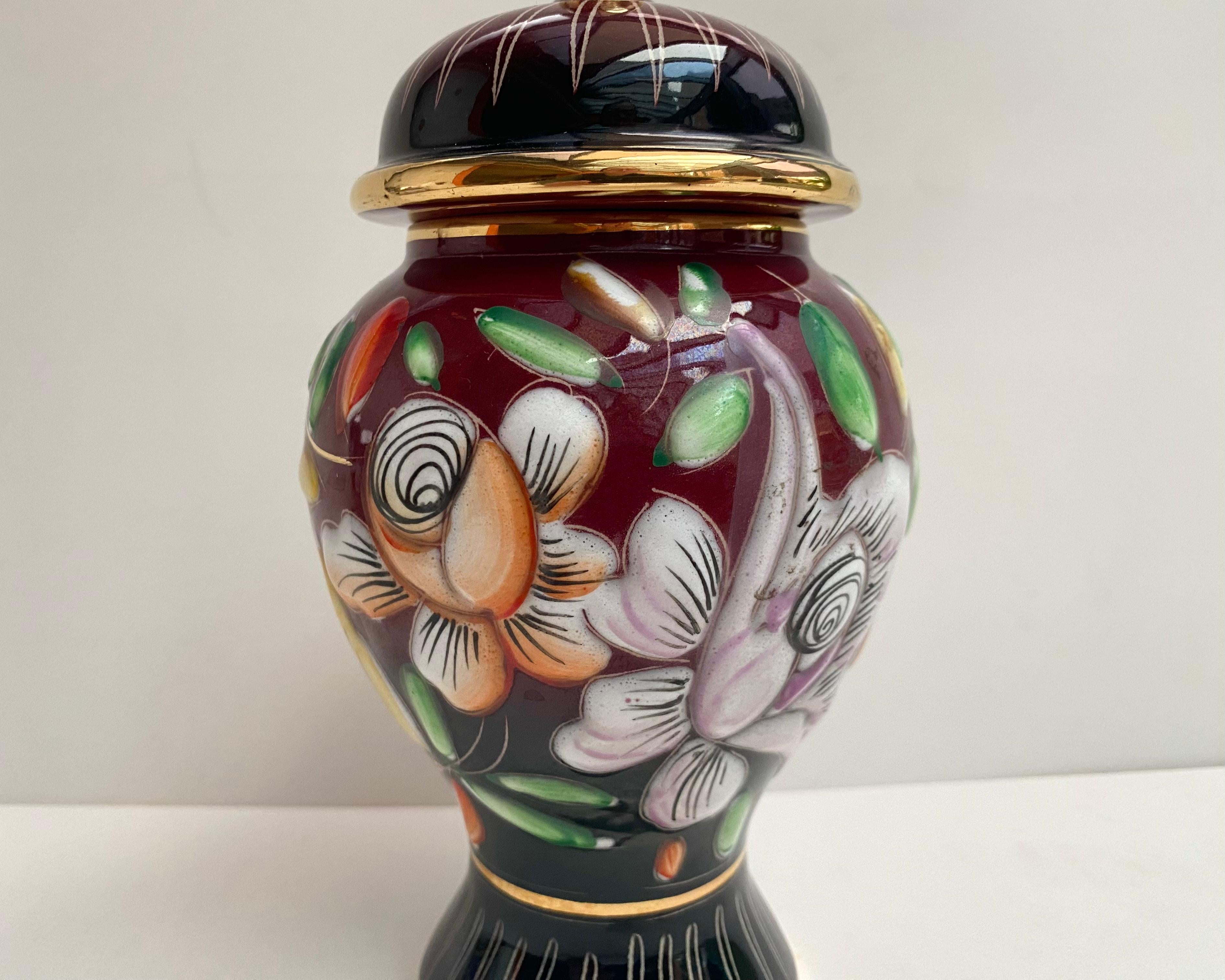 Rare Vintage Vase/Urn with lid from 1950s by Hubert Bequet made of precious ceramic with pure 24k gold processing.

From the 1950s. Manufactured in Belgium.

Entirely handmade by master craftsmen, it features floral decoration on a burgundy