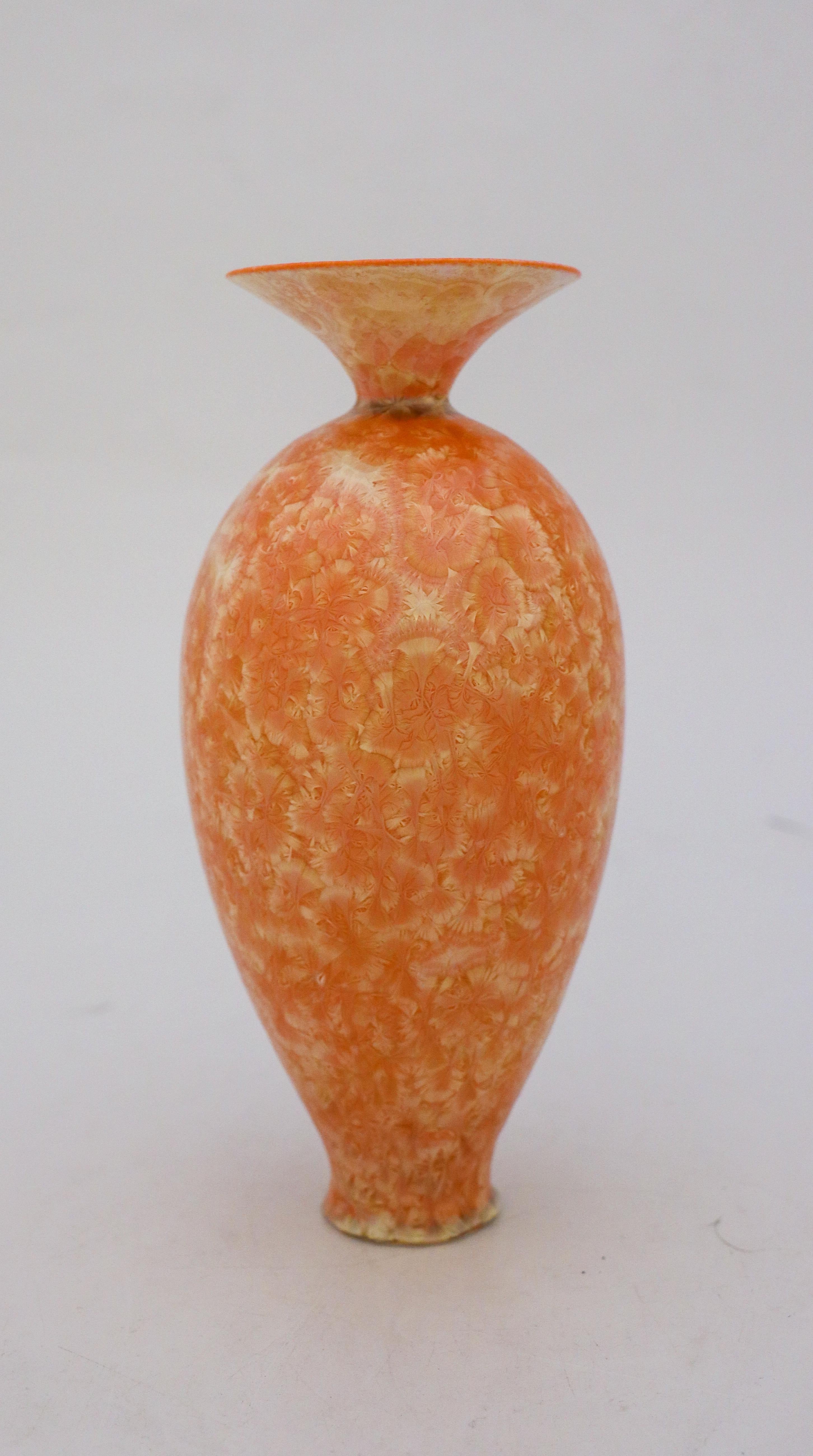 A unique vase in a Apricot shade tone with a lovely crystalline glaze created by the contemporary Swedish artist Isak Isaksson in his own studio. The vase is 20 cm (8