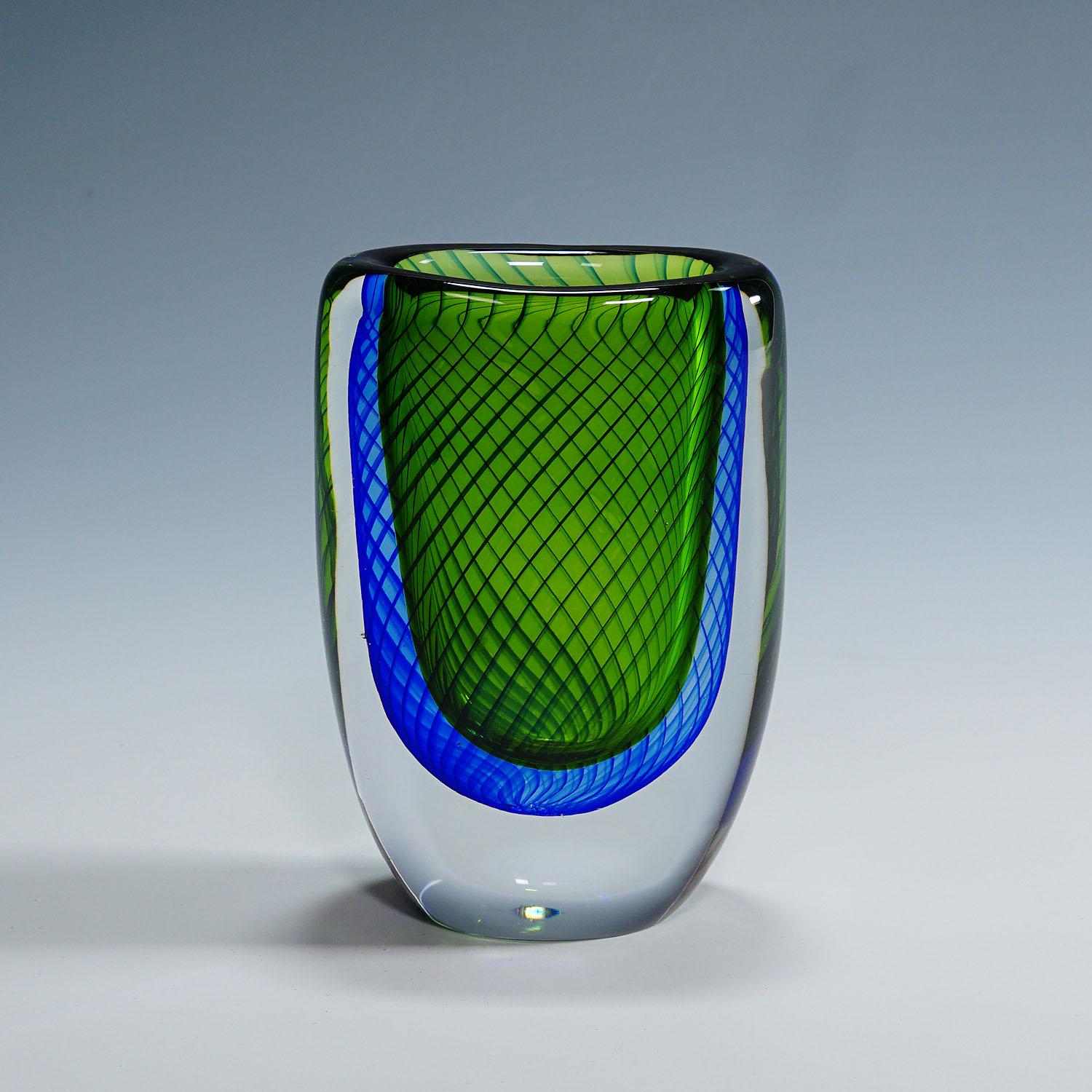 Vase with Blue and Green Layers, Vicke Lindstrand for Kosta 1950s

A vintage art glass vase designed by Vicke Lindstrand and manufactured by Kosta Glasbruk ca. 1950s. The vase features blue and a green glass layers with clear glass overlay and a