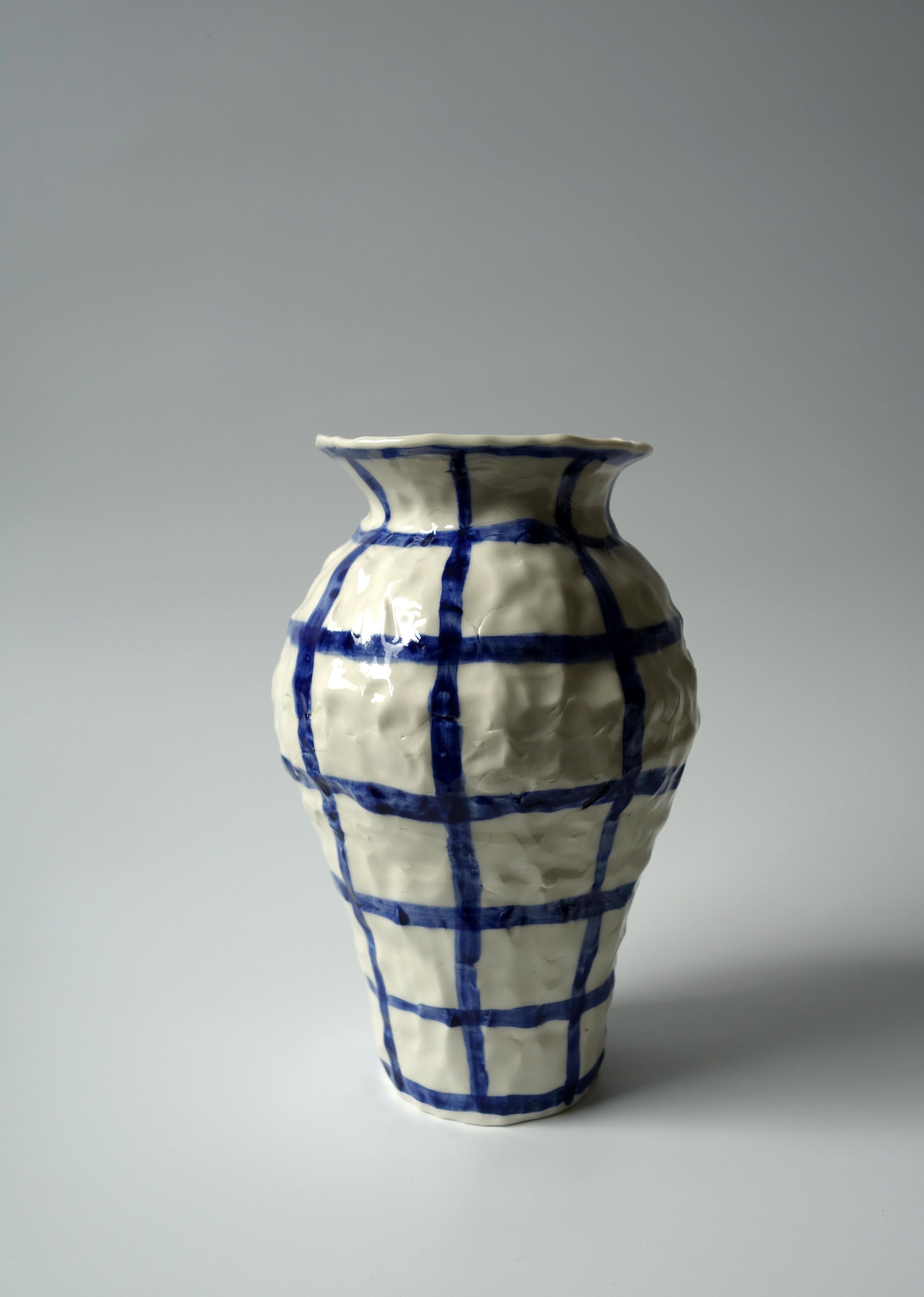 Vase with checkers by Caroline Harrius
Dimensions: 22 H cm
Material: Porcelain

Vase with checkers, Also available: a few of these in different sizes and some with different patterns. They are colied in porcelain and glazed on the inside. Sizes