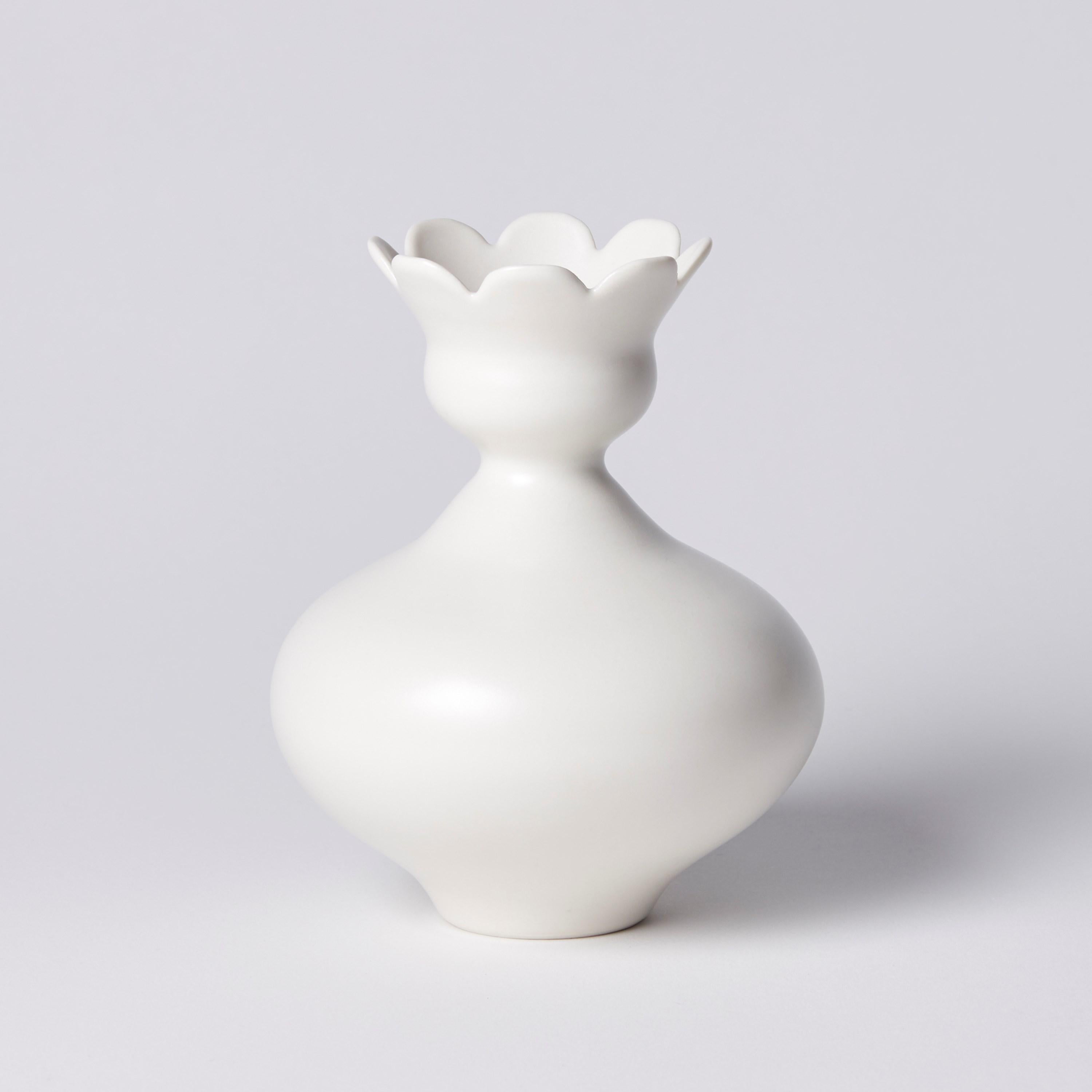 ‘Vase with Daisy Rim' is a unique porcelain sculptural vessel by the British artist, Vivienne Foley.  

Vivienne Foley is based in Gloucestershire where she produces exquisite ceramic sculpture. Although in essence they are often functional pieces