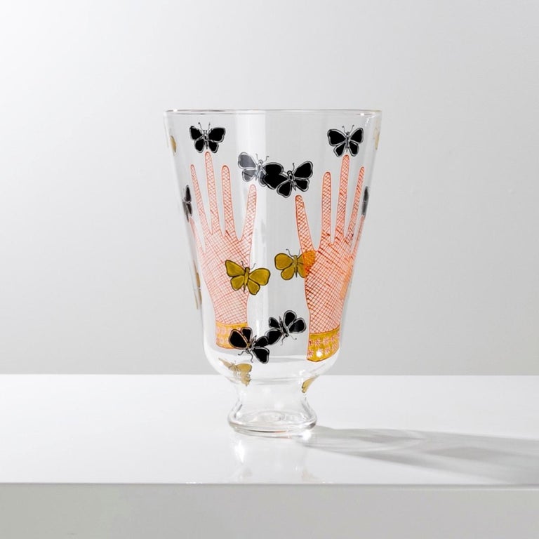 About this vase with hands and butterflies (Mani con Farfalle a Smalti vase) by Piero Fornasetti
Transparent blown glass vase on a pedestal.
The vase is entirely enamelled by hand.
It is decorated with drawings of two hands surrounded by