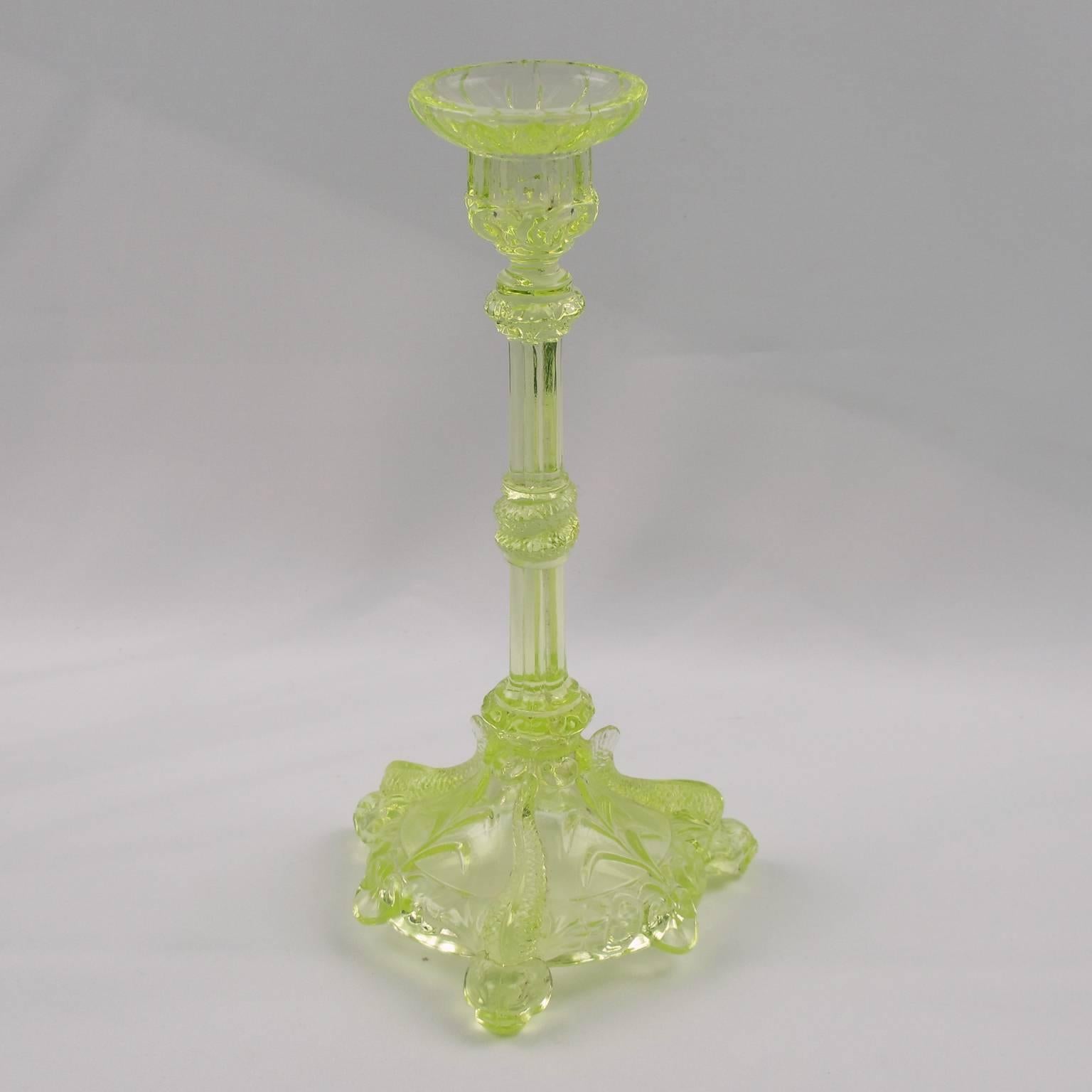 Charming French Vaseline uranium (also called Ouraline) pressed crystal candlestick, candleholder, by Cristallerie Portieux, France. Elegant shape with lots of details in the molding design, unusual three feet featuring huge fish, coiled snake on