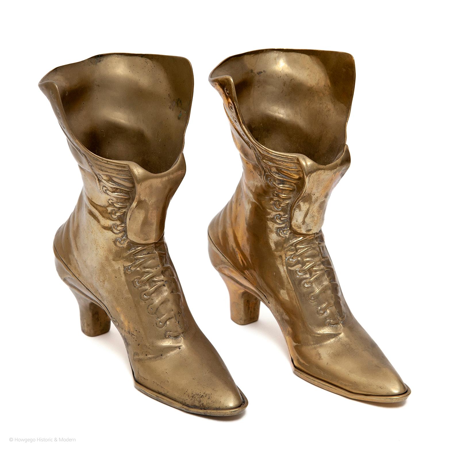- Unusual pair of Victorian-style brass boots
- Beautifully cast
- Shoes are steeped in custom, symbolic meaning and stories; Cinderella, Dorothy. Shoes were offered as gifts on special occasions in the 17th and 18th centuries often exchanged