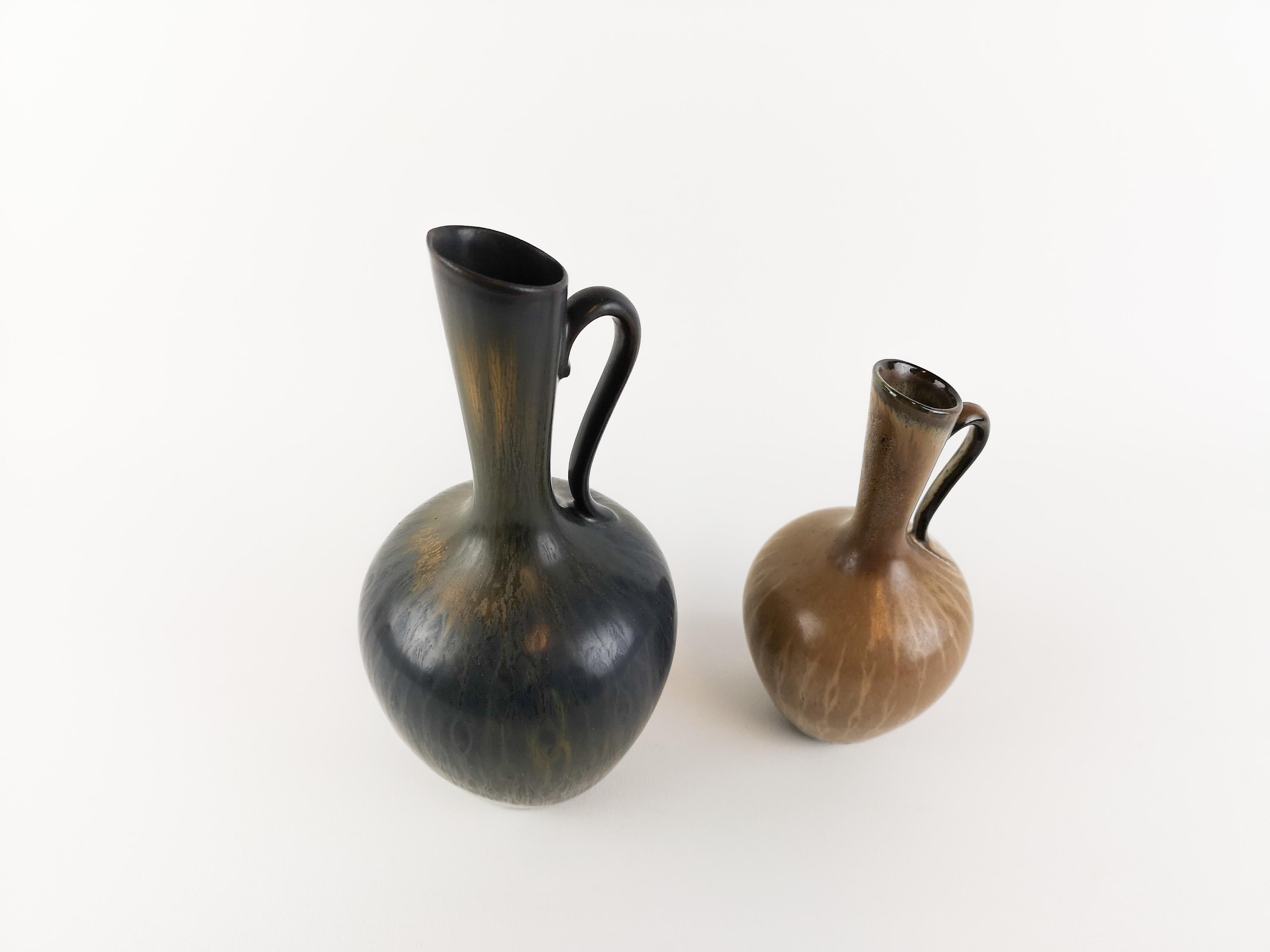 Two wonderful Peacock Vases from Rörstrand and maker/designer Gunnar Nylund. Made in Sweden in the midcentury. Beautiful glazed vases in good condition.

The big one measures H 23 D 10 cm. The small one measures H 17 D8.