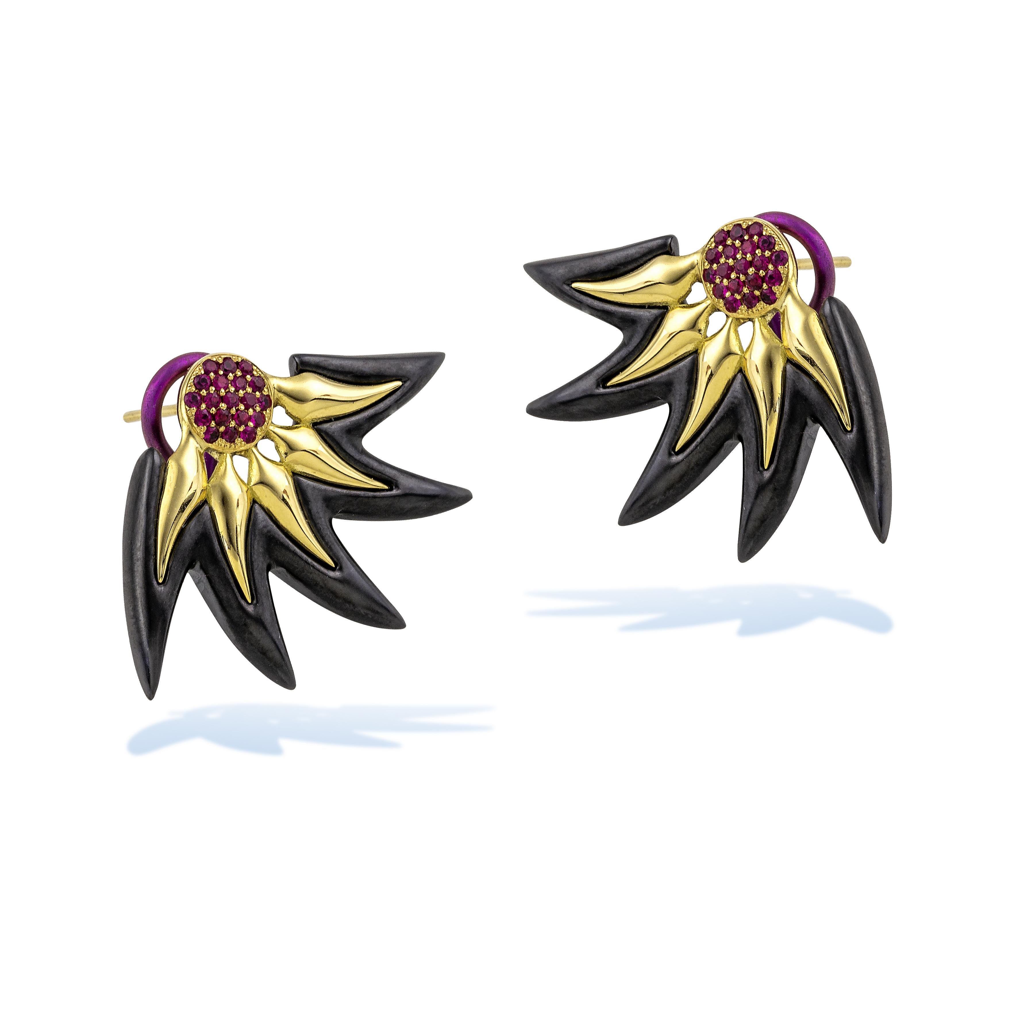 Flame Stud Earrings by Vasilis Giampouras at Second Petale Gallery
This fashionable pair of earrings combines Black Titanium, 18K Gold, and rubies to create an enchanting effect, making them a bold statement for those who appreciate the fusion of