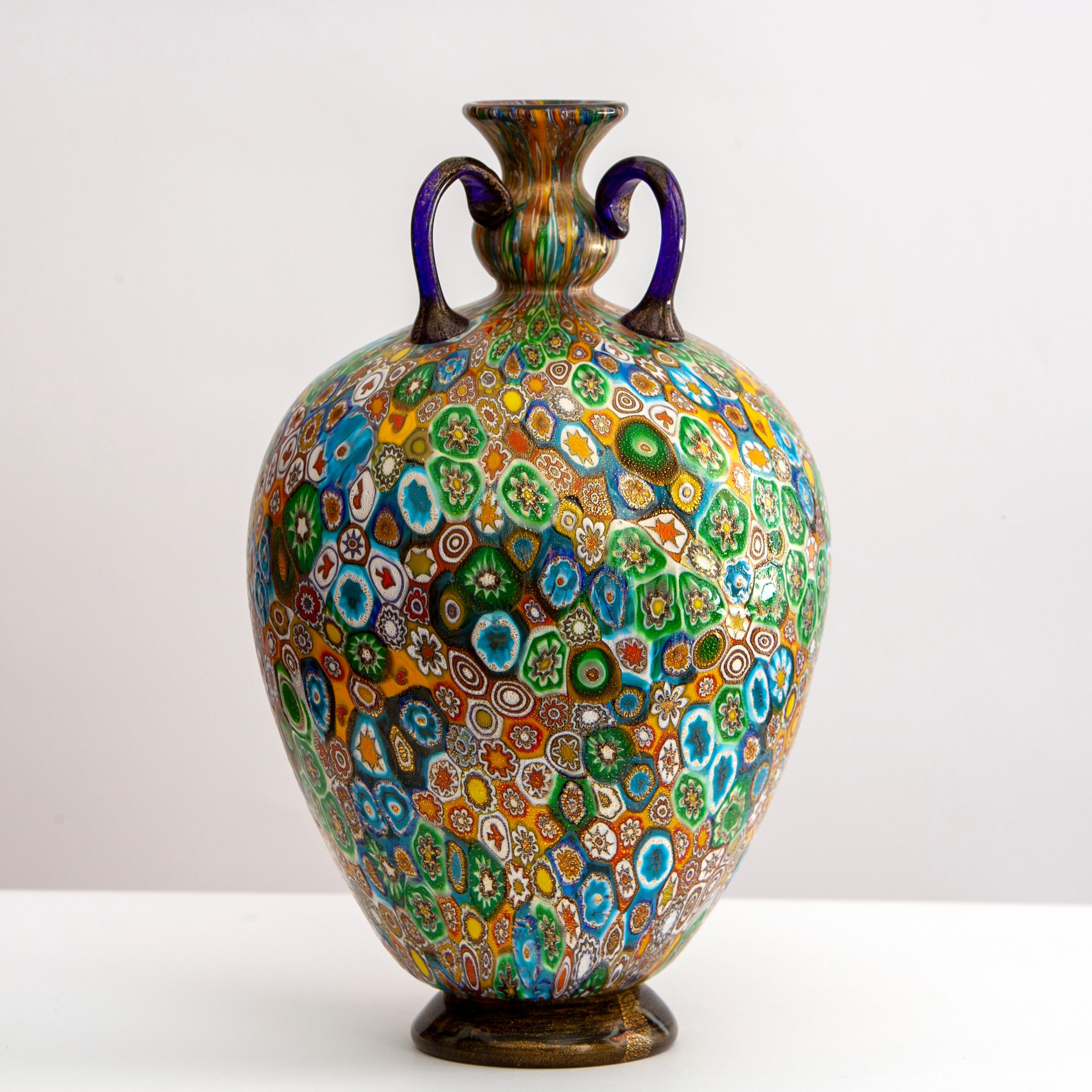 Vaso in vetro soffiato realizzato da Vivarini.
Vivarini è una vetreria artistica nata a Murano nel 1967

Tecnica a murrine, piccoli elementi in vetro sono accostati e poi fusi insieme a formare una superficie detta millefiori. La superficie è poi
