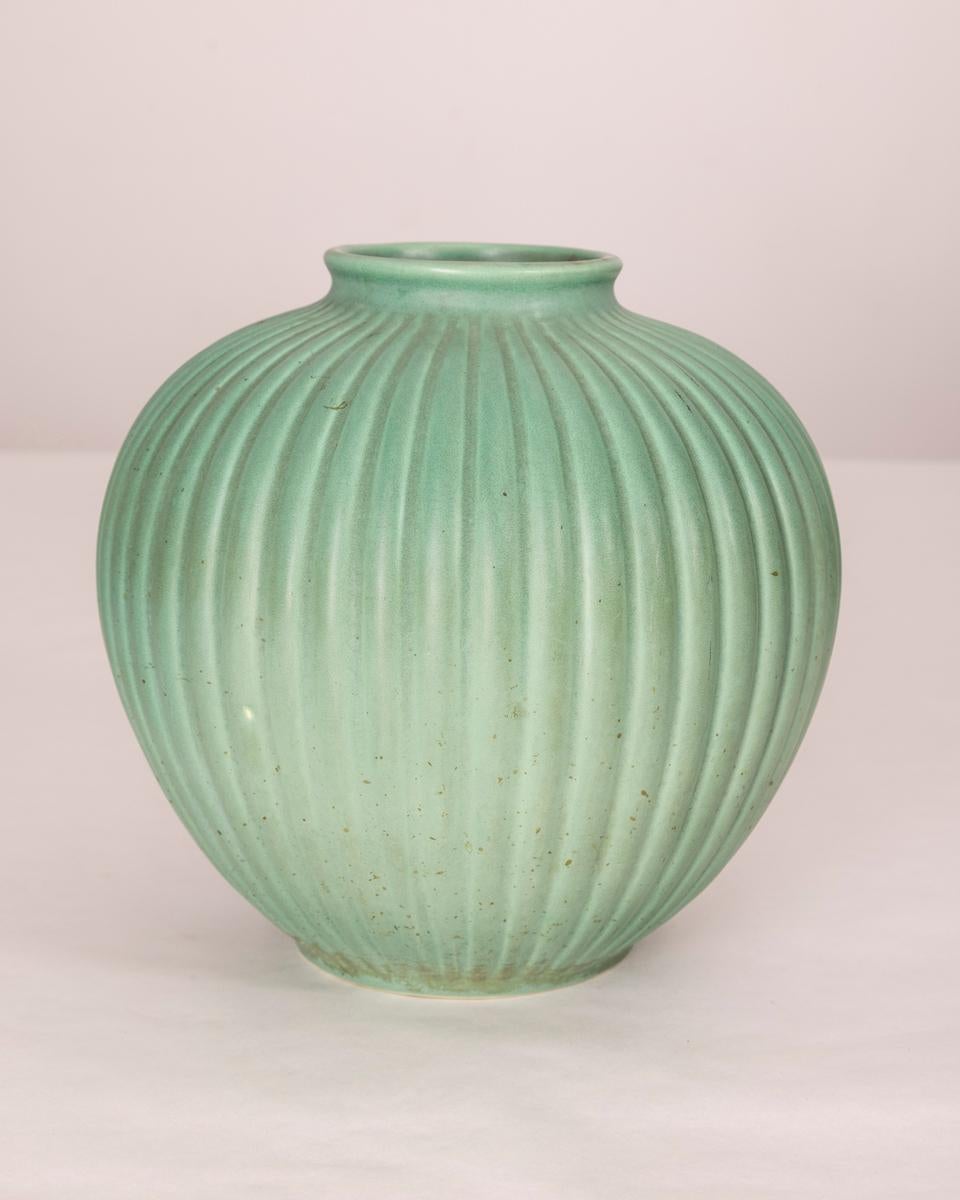 Green ceramic vase with vertical ribbing, design Giovanni Gariboldi for Richard Ginori, 1950s.

CONDITION: In fair condition, shows signs of wear given by time visible in photo.

DIMENSIONS: Height 25 cm; Diameter 26 cm

MATERIAL: Ceramic

YEAR OF